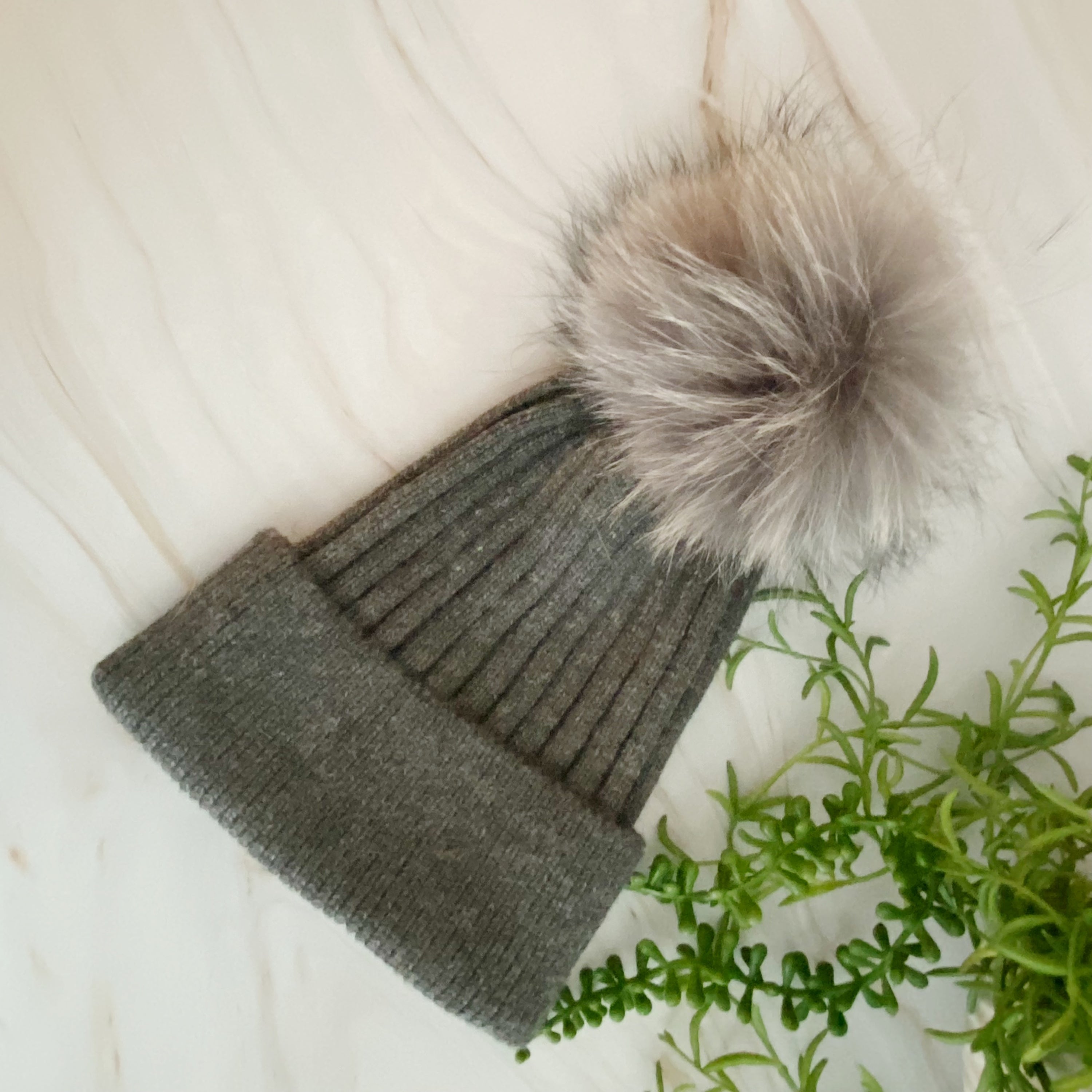 Luxurious Pure Angora Genuine Fur Luxe Beanie with raccoon fur pom pom, showcasing a soft knit design in a stylish fold-over style.