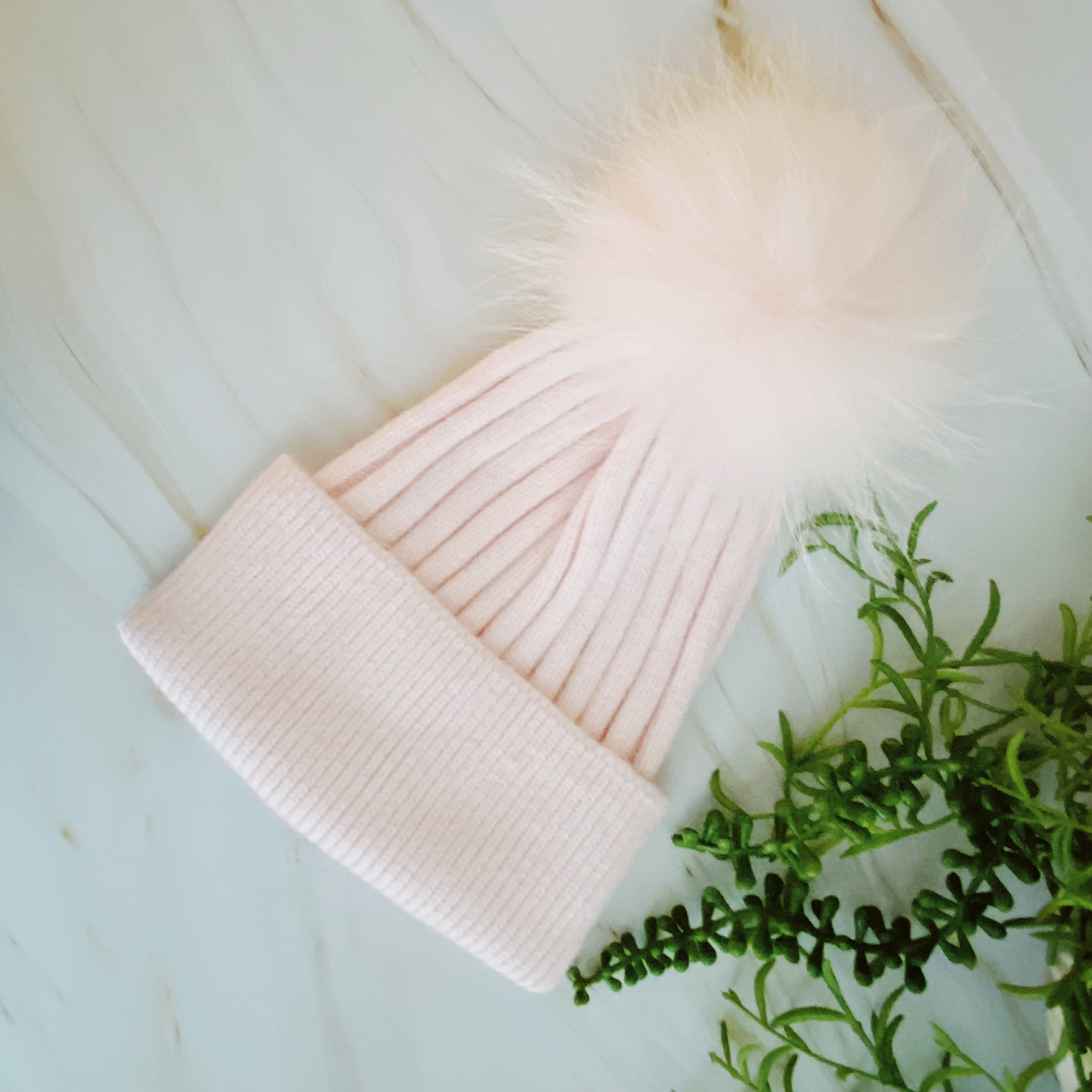 Luxurious Pure Angora Genuine Fur Luxe Beanie with raccoon fur pom pom, showcasing a soft knit design in a stylish fold-over style.