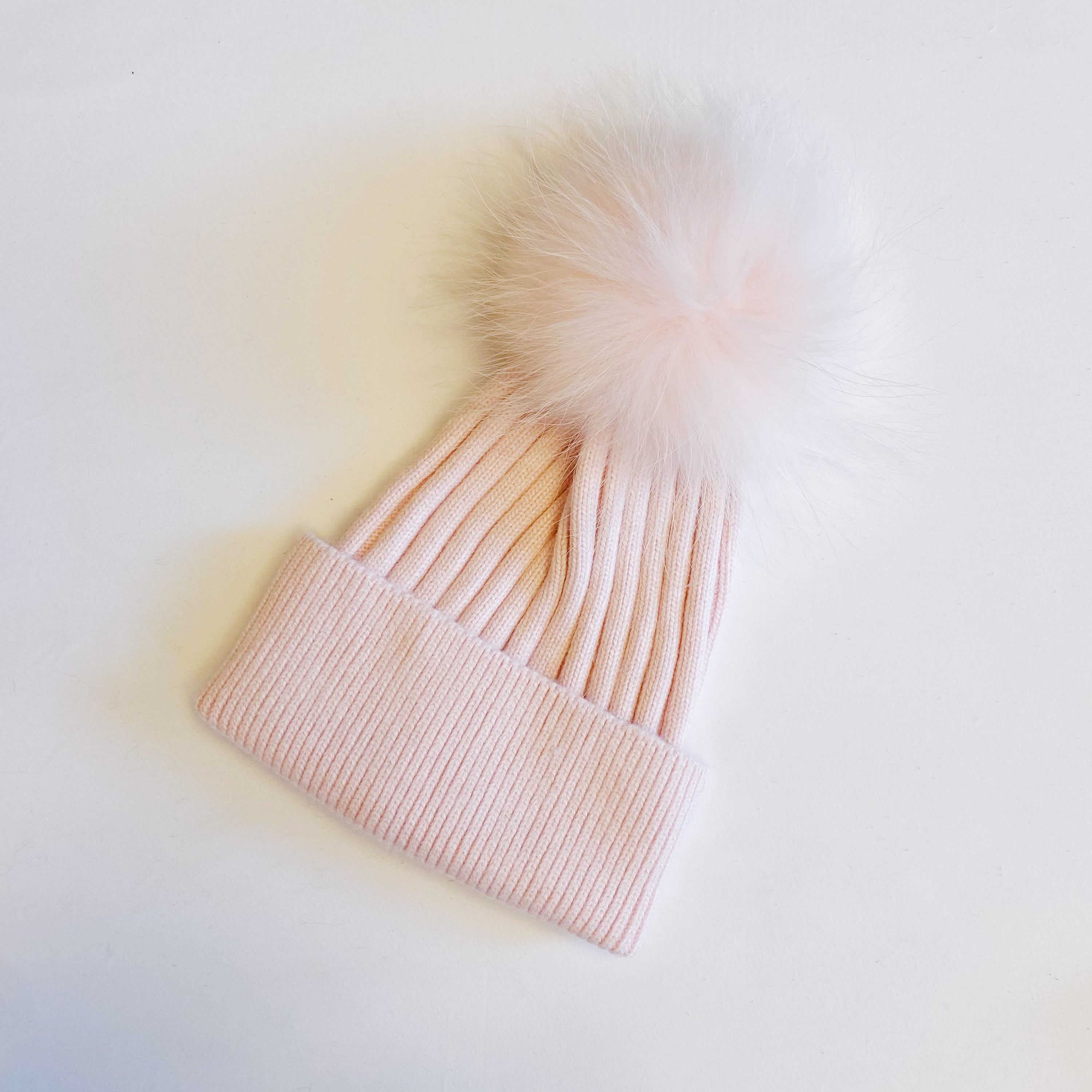 Luxurious Pure Angora Genuine Fur Luxe Beanie with raccoon fur pom pom, showcasing a soft knit design in a stylish fold-over style.