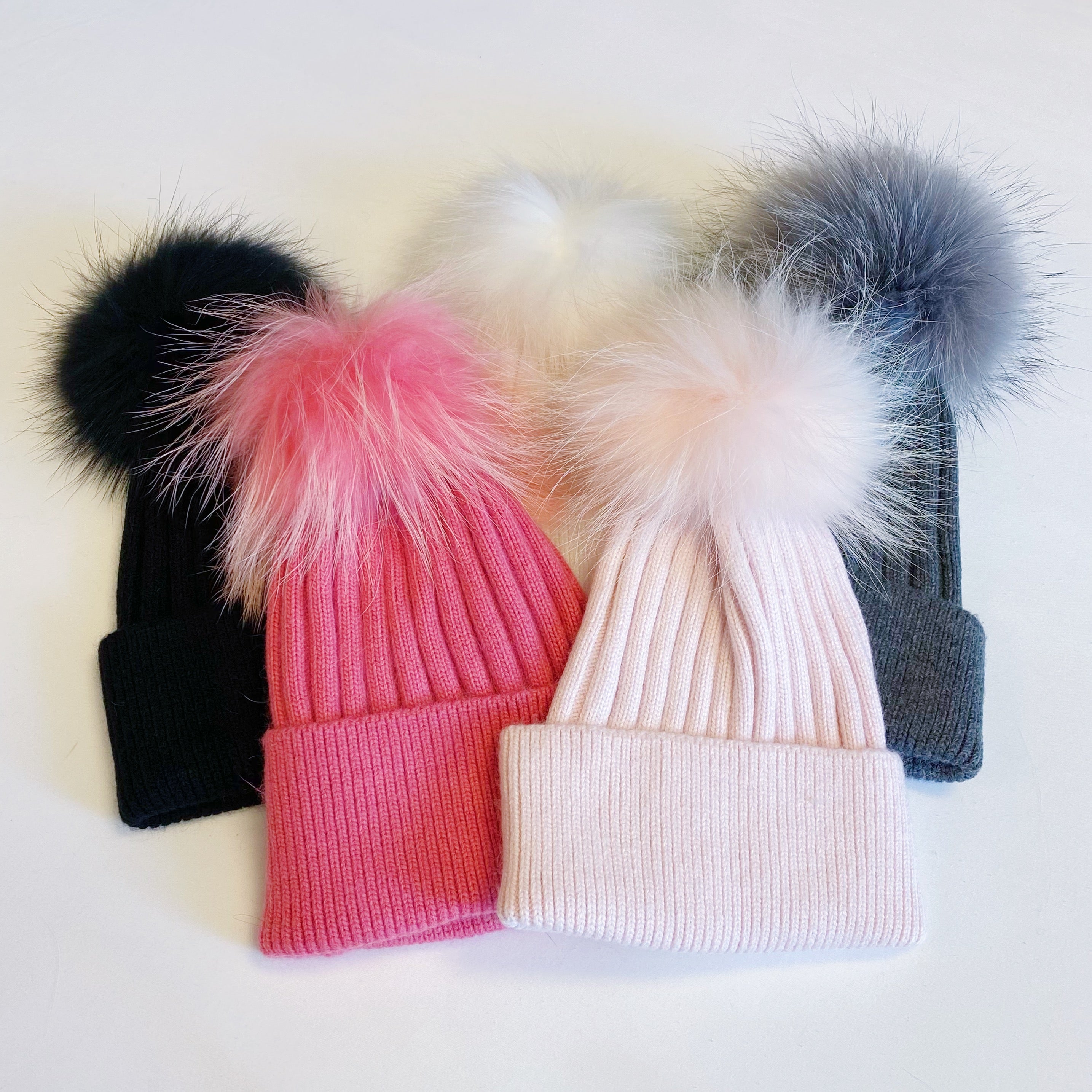 Luxurious Pure Angora Genuine Fur Luxe Beanie with raccoon fur pom pom, showcasing a soft knit design in a stylish fold-over style.