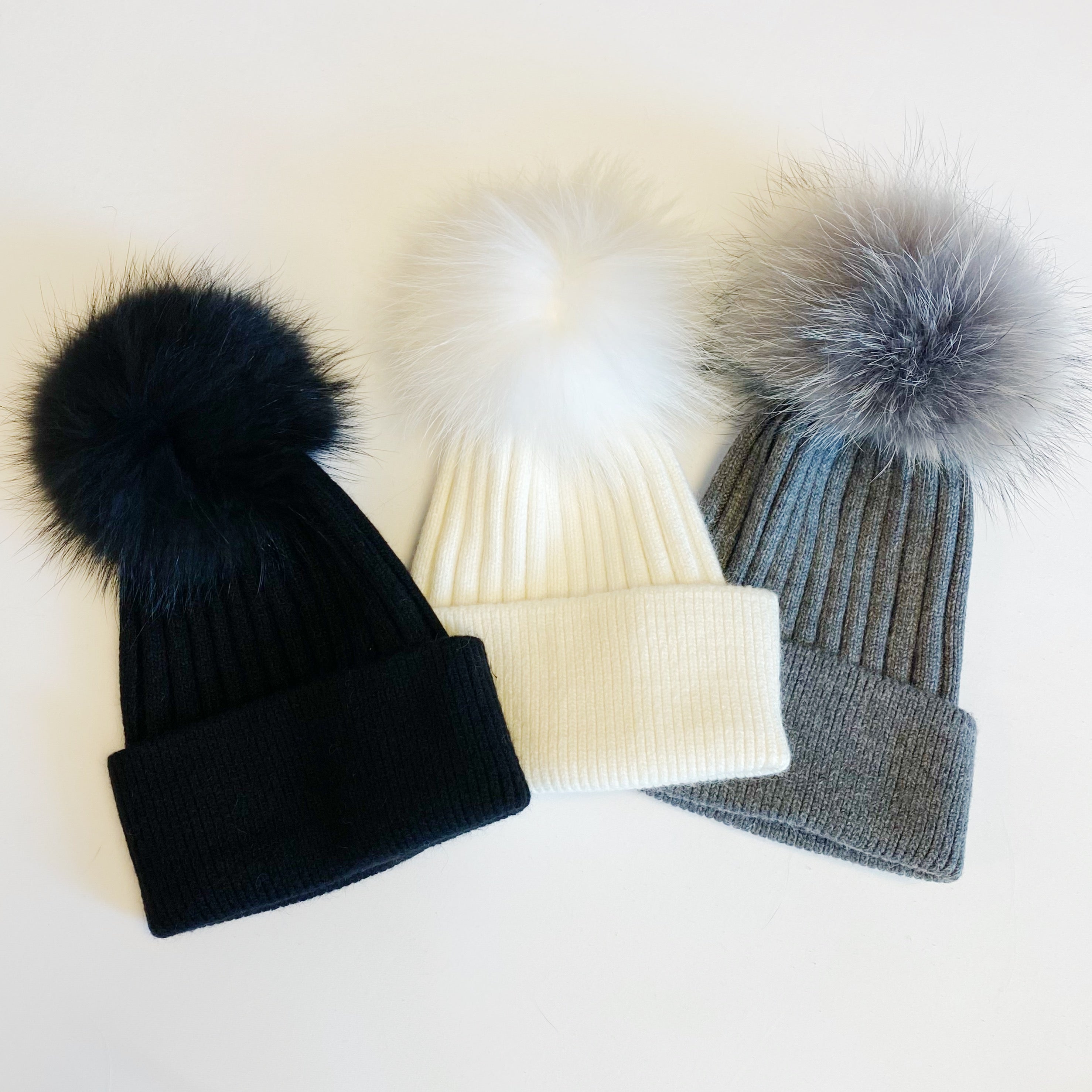 Luxurious Pure Angora Genuine Fur Luxe Beanie with raccoon fur pom pom, showcasing a soft knit design in a stylish fold-over style.