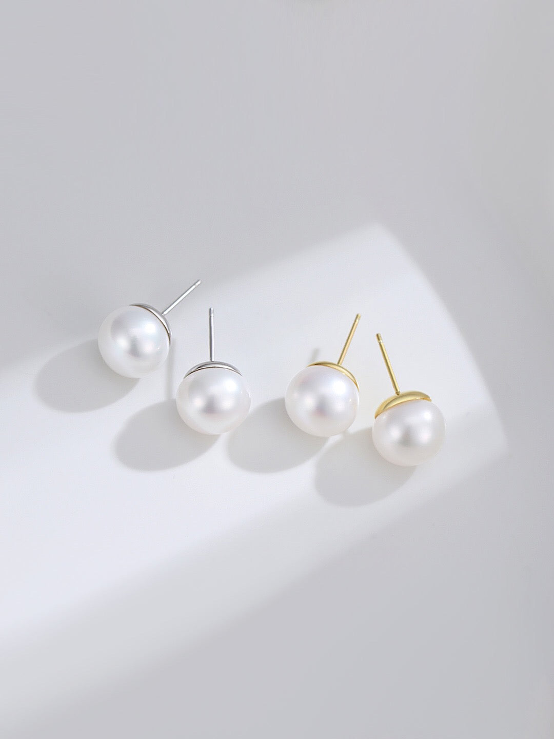 A pair of elegant Pure Freshwater Pearl Stud Earrings featuring natural pearls set in sterling silver and gold vermeil.