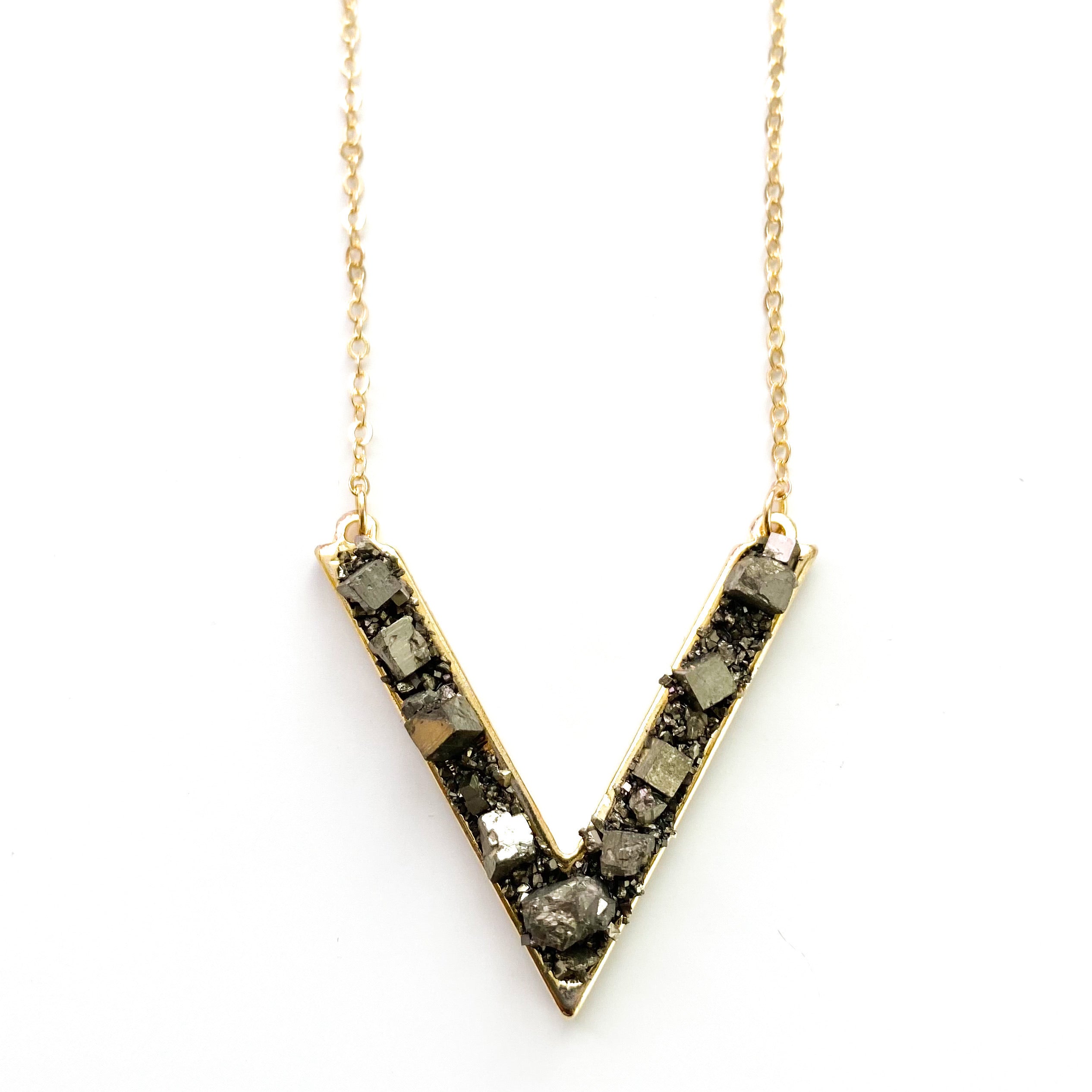 A handmade Purely Pyrite Necklace featuring pyrite nuggets on an 18K gold plated link chain, elegantly designed in a 'V' shape.