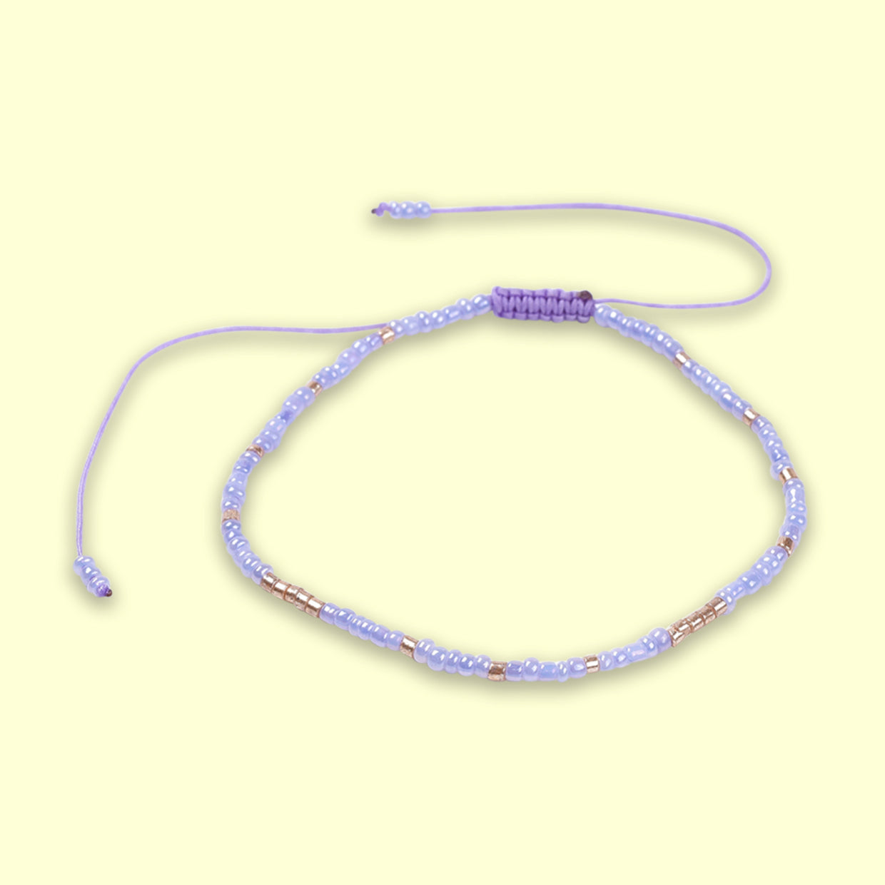 Purple Beaded Friendship Bracelet with adjustable cord and delicate glass seed beads, symbolizing love and friendship.