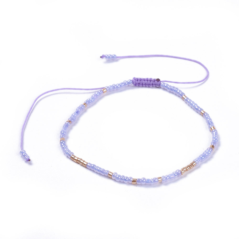 Purple Beaded Friendship Bracelet with adjustable cord and delicate glass seed beads, symbolizing love and friendship.