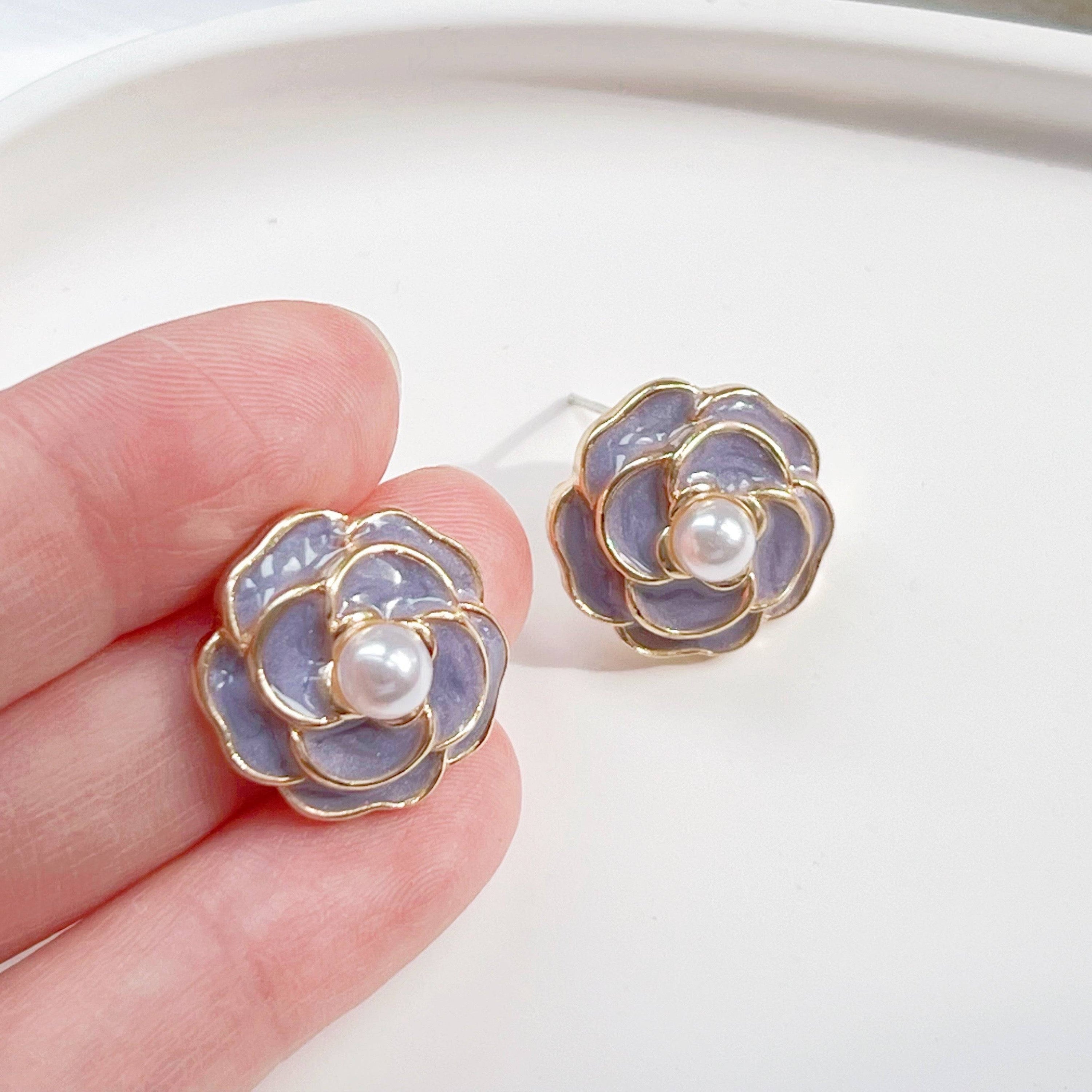 Purple Camellia earrings in flower shape with pearl accents, crafted from sterling silver and gold plated sterling silver.