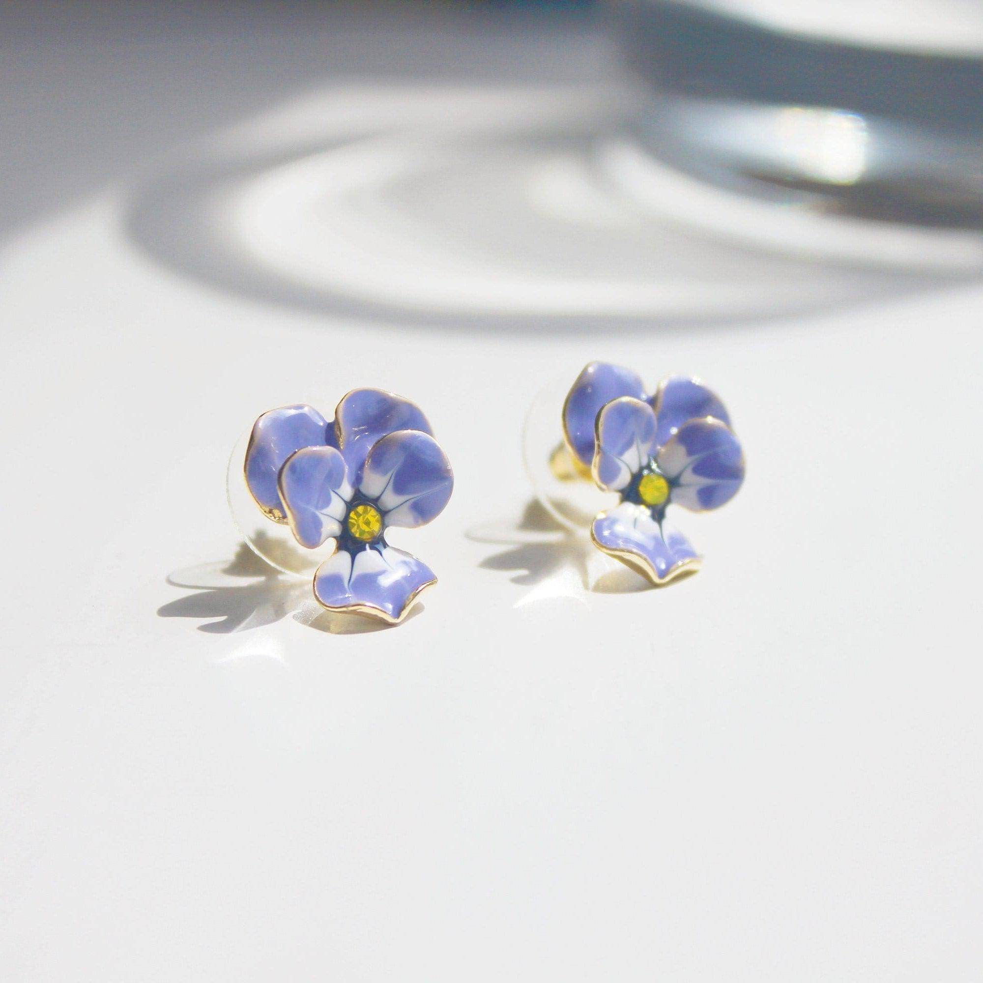 A pair of elegant purple and yellow pansy flower stud earrings made from sterling silver and bronze with enamel coating.