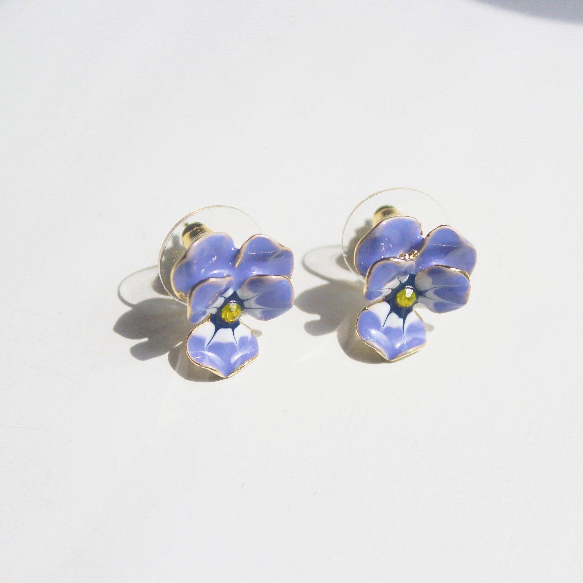 A pair of elegant purple and yellow pansy flower stud earrings made from sterling silver and bronze with enamel coating.