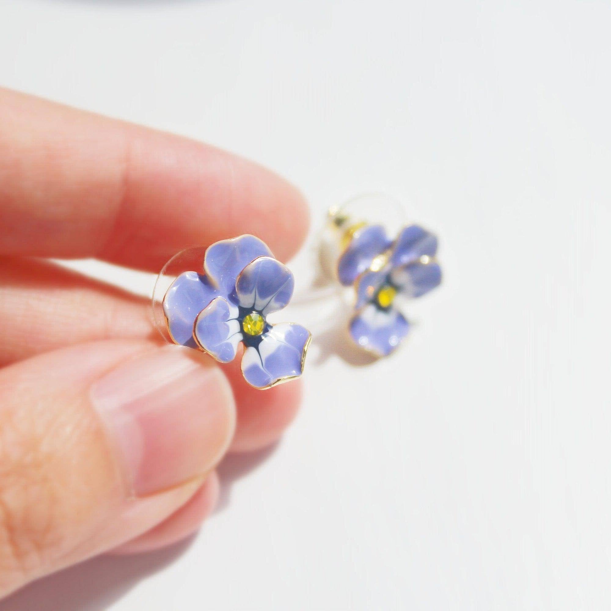 A pair of elegant purple and yellow pansy flower stud earrings made from sterling silver and bronze with enamel coating.