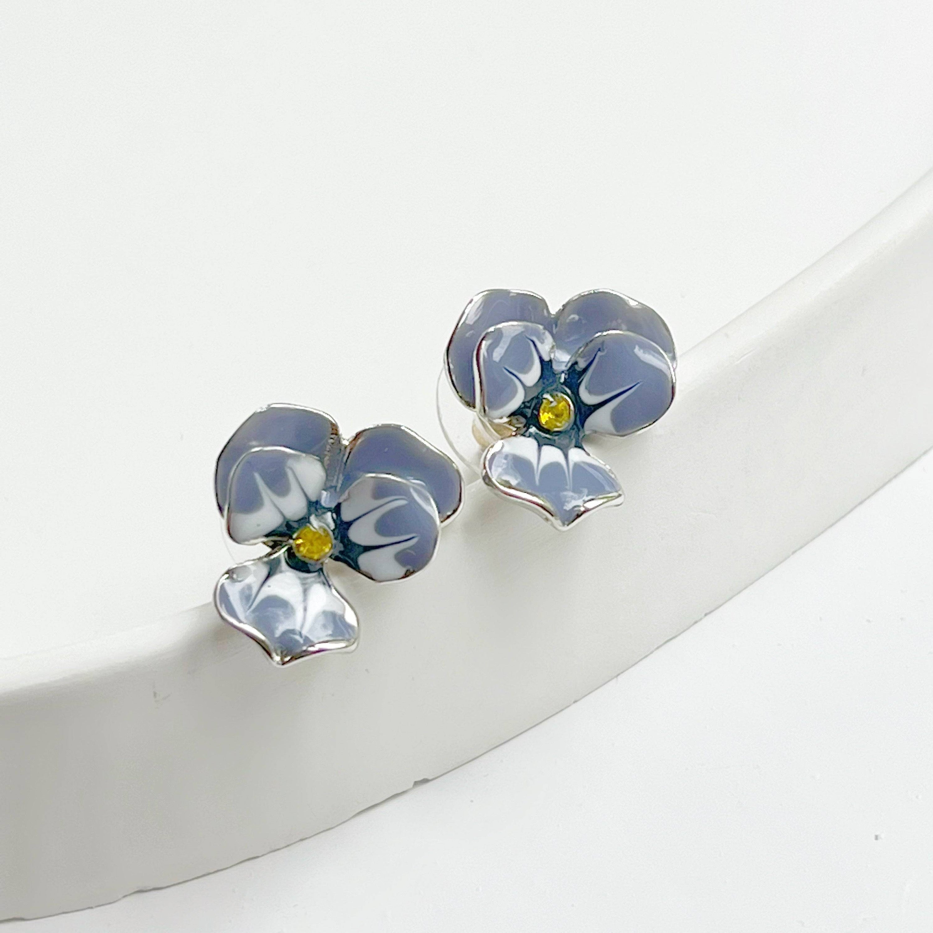 Purple Pansy Flower Earrings with silver base and enamel finish, showcasing vibrant colors and elegant design.