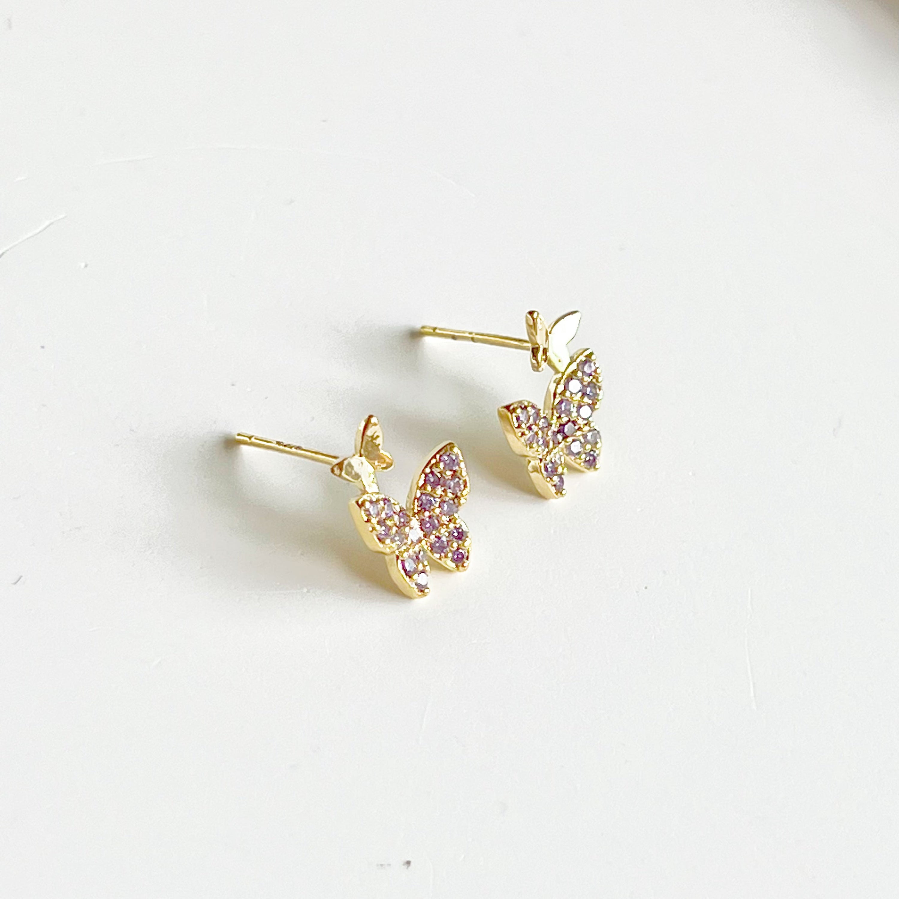 Elegant Purple Zircon Butterflies Earrings made from gold-plated sterling silver and bronze, featuring sparkling purple zircon stones.