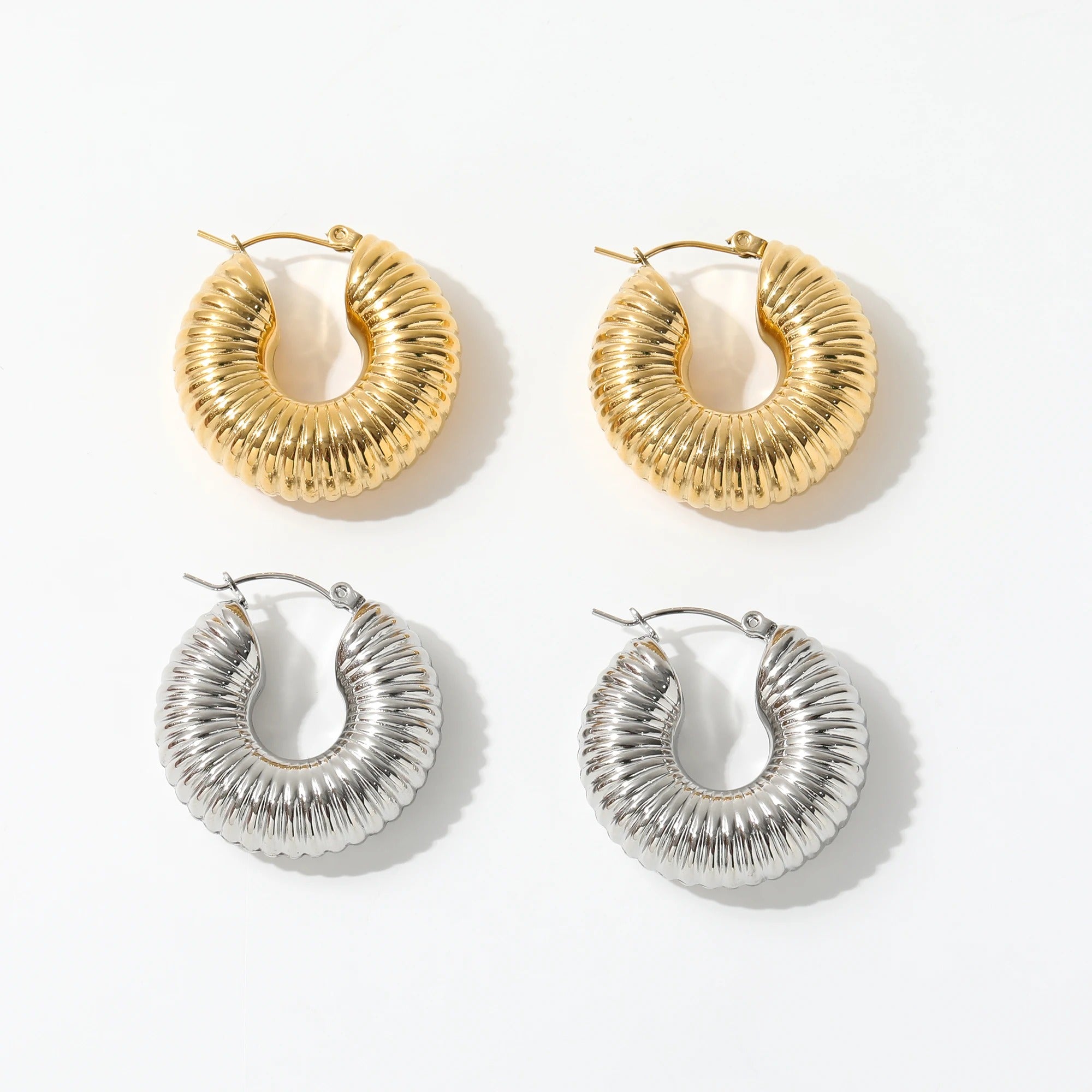 Qin Shell Earrings featuring chunky scallop design in gold, made from stainless steel with 18Kt yellow gold coating.