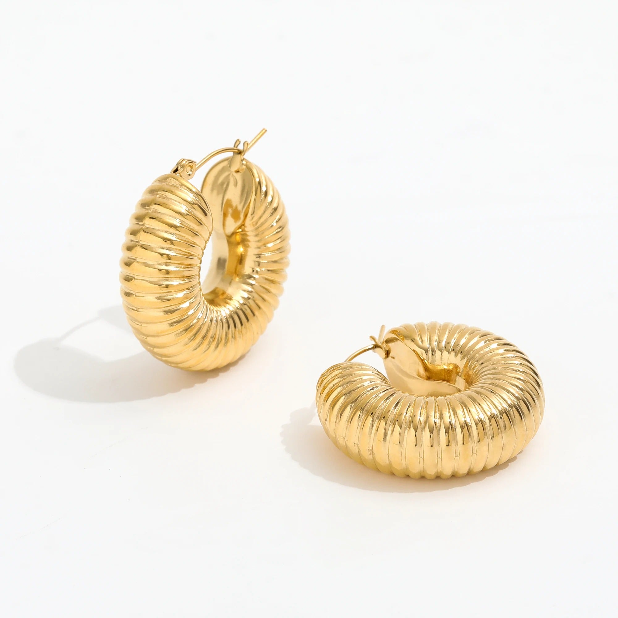 Qin Shell Earrings featuring chunky scallop design in gold, made from stainless steel with 18Kt yellow gold coating.