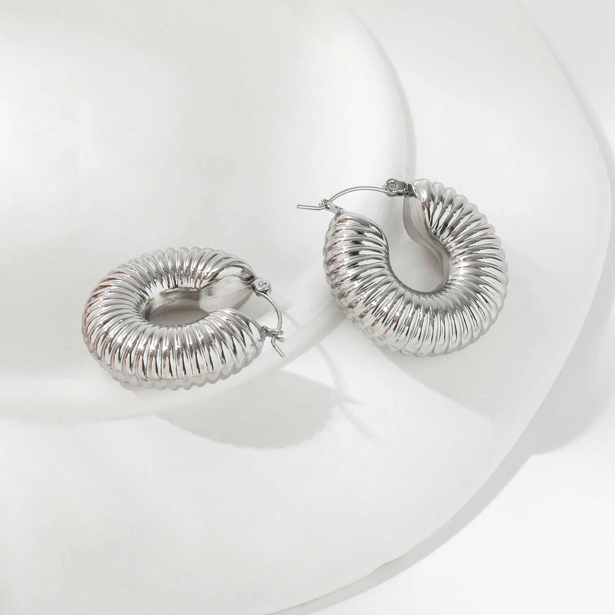 Qin Shell Earrings featuring chunky scallop design in gold, made from stainless steel with 18Kt yellow gold coating.