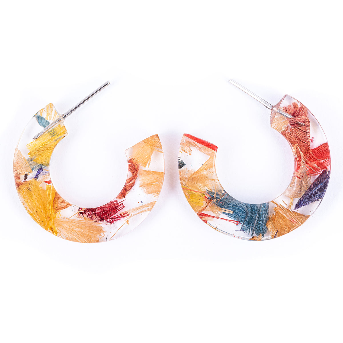 Quartilla Eco Friendly Resin Hoop Earrings made from recycled skateboard wood shavings and plant resin, showcasing vibrant colors and unique patterns.