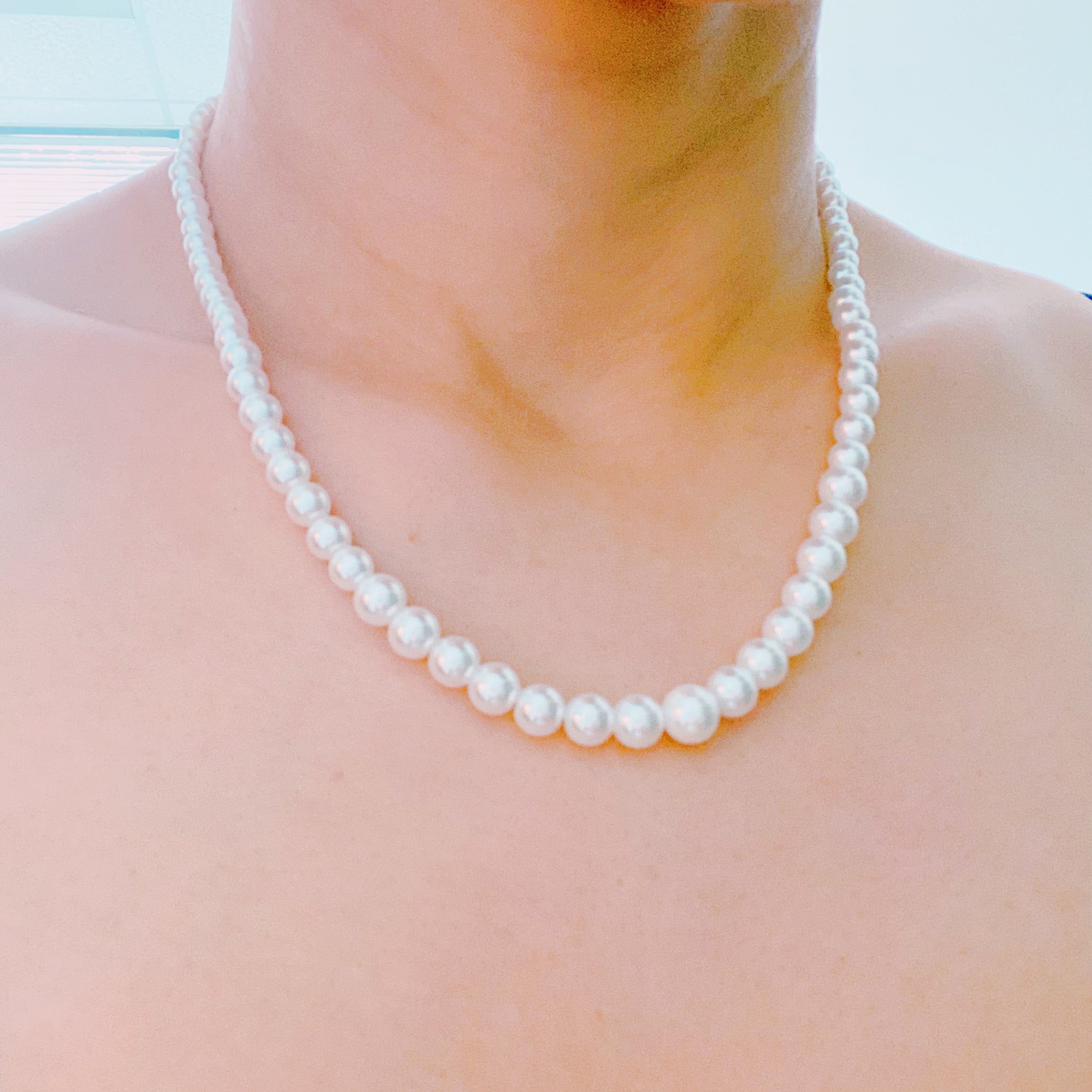 Queen Liz Graduated Pearl Necklace featuring graduated glass pearls from 4mm to 7mm with an 18k gold-plated brass closure.