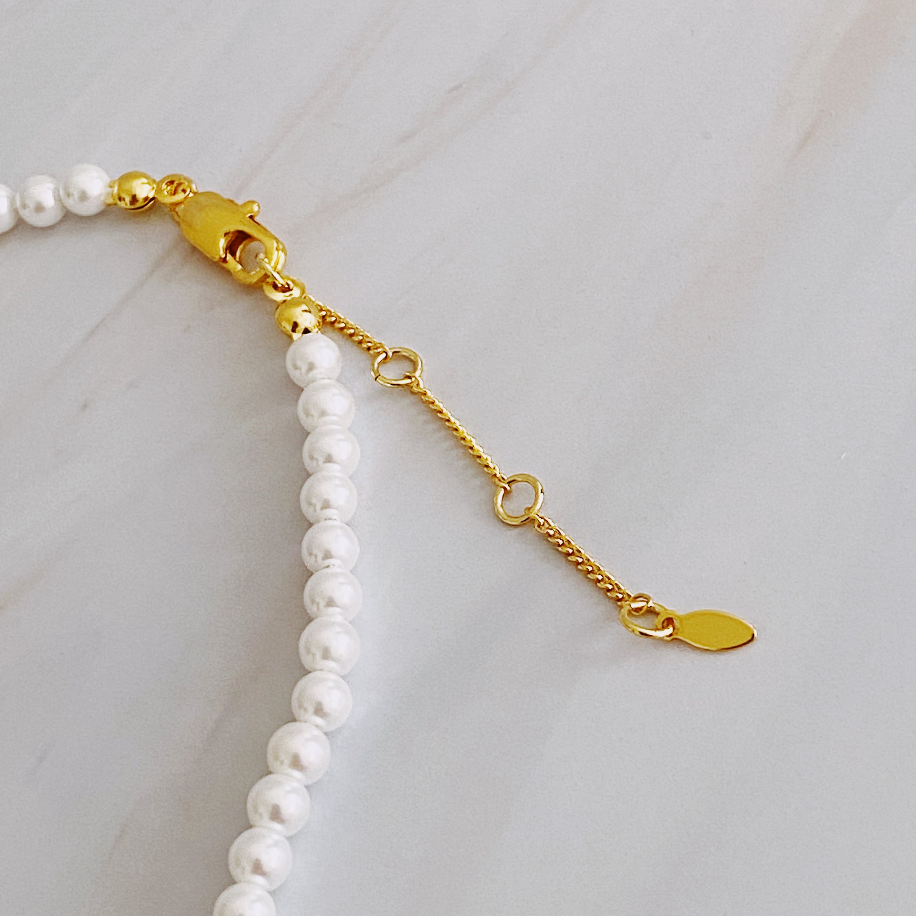 Queen Liz Graduated Pearl Necklace featuring graduated glass pearls from 4mm to 7mm with an 18k gold-plated brass closure.