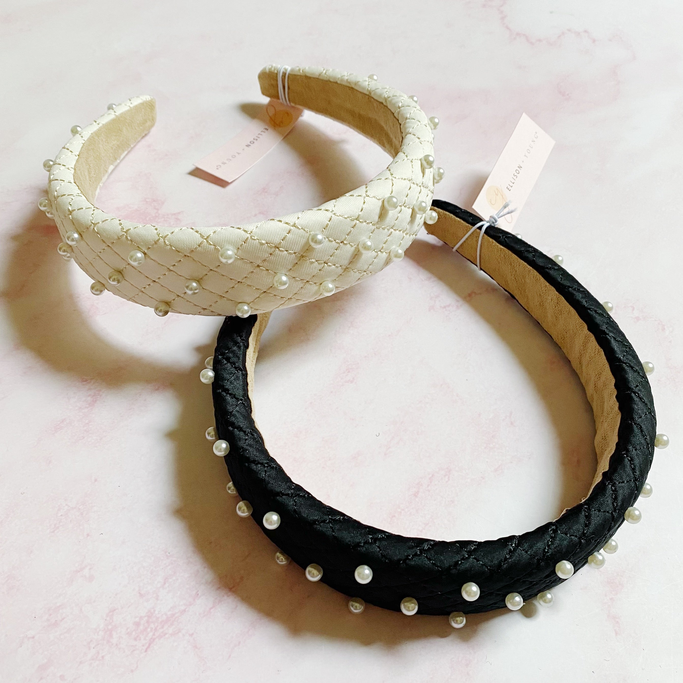 Quilted Elegance Pearl Headband featuring quilted fabric and hand-nailed small pearls, perfect for elegant styling.