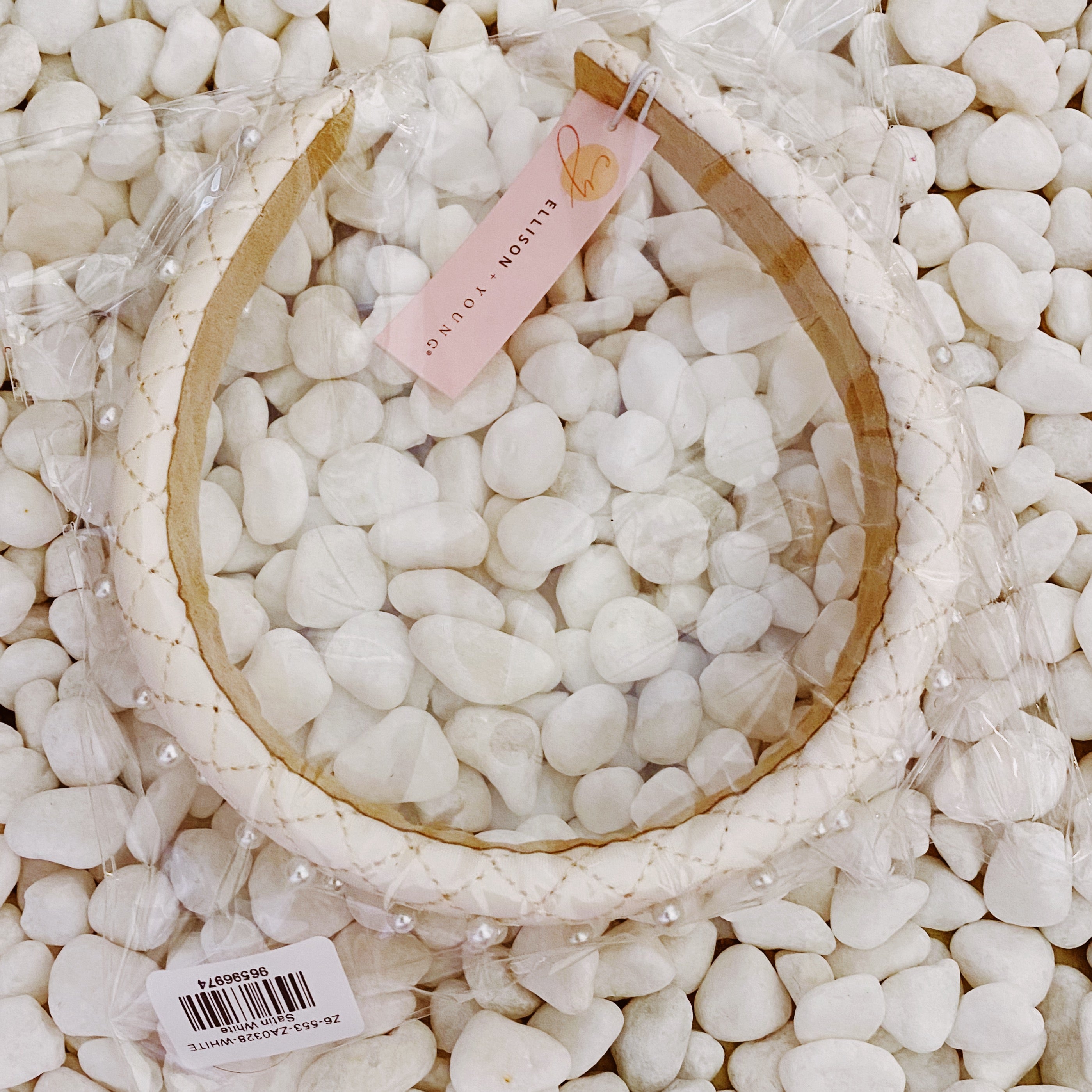 Quilted Elegance Pearl Headband featuring quilted fabric and hand-nailed small pearls, perfect for elegant styling.