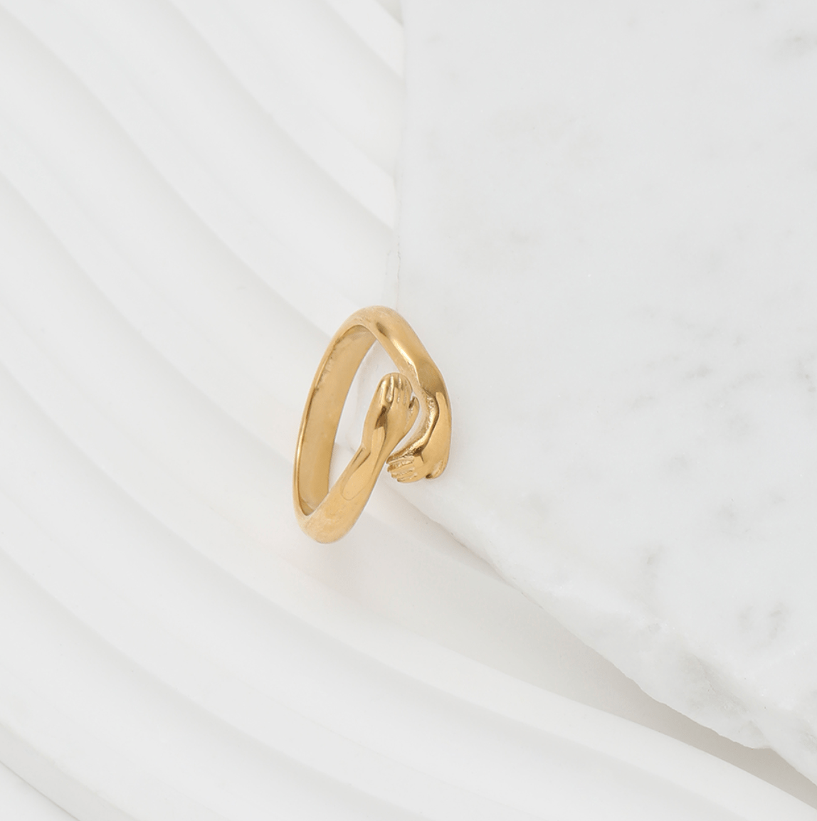 Quinn Love Hug Ring featuring a unique adjustable design in stainless steel with 18Kt yellow gold coating.