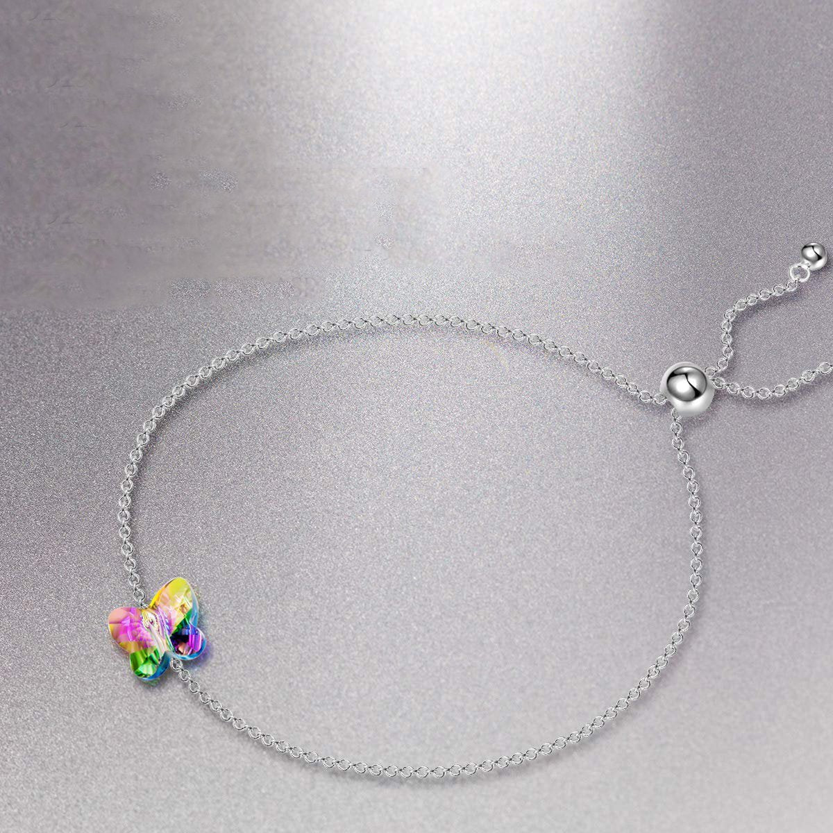 A beautiful Rainbow Aurora Borealis Butterfly Pendant Bracelet made of 14K white gold plating, featuring a colorful butterfly pendant and link chain.