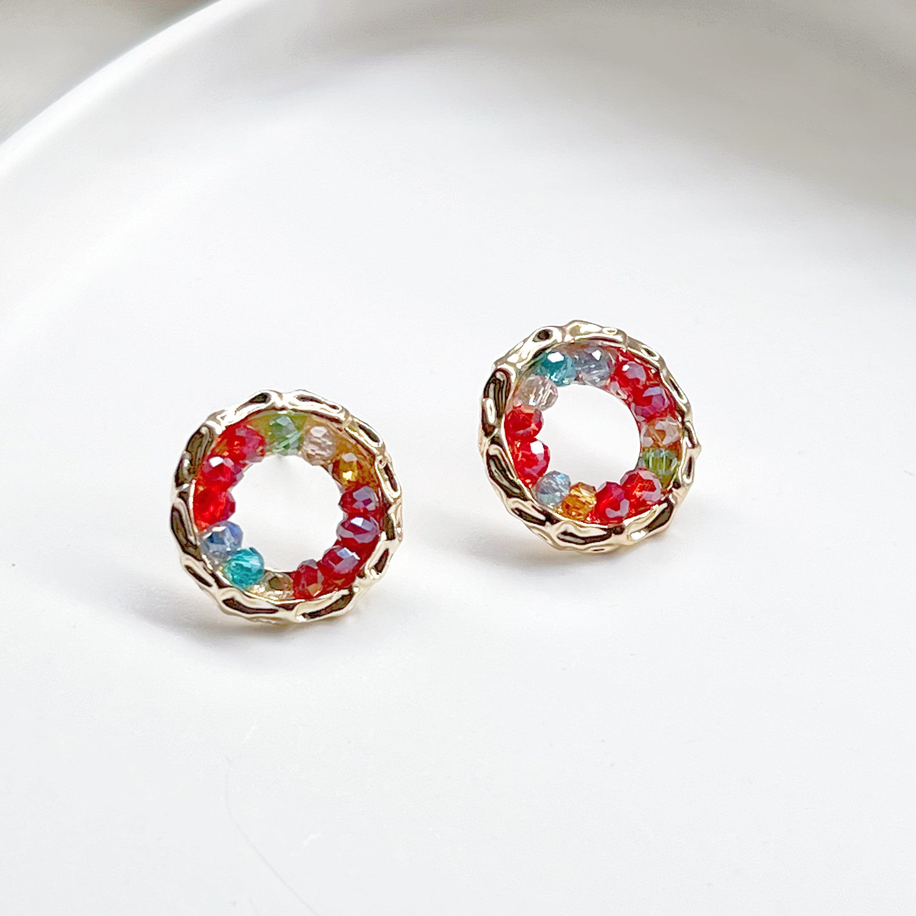 Colorful rainbow beads in a gold circle stud earring design, perfect for summer outfits.