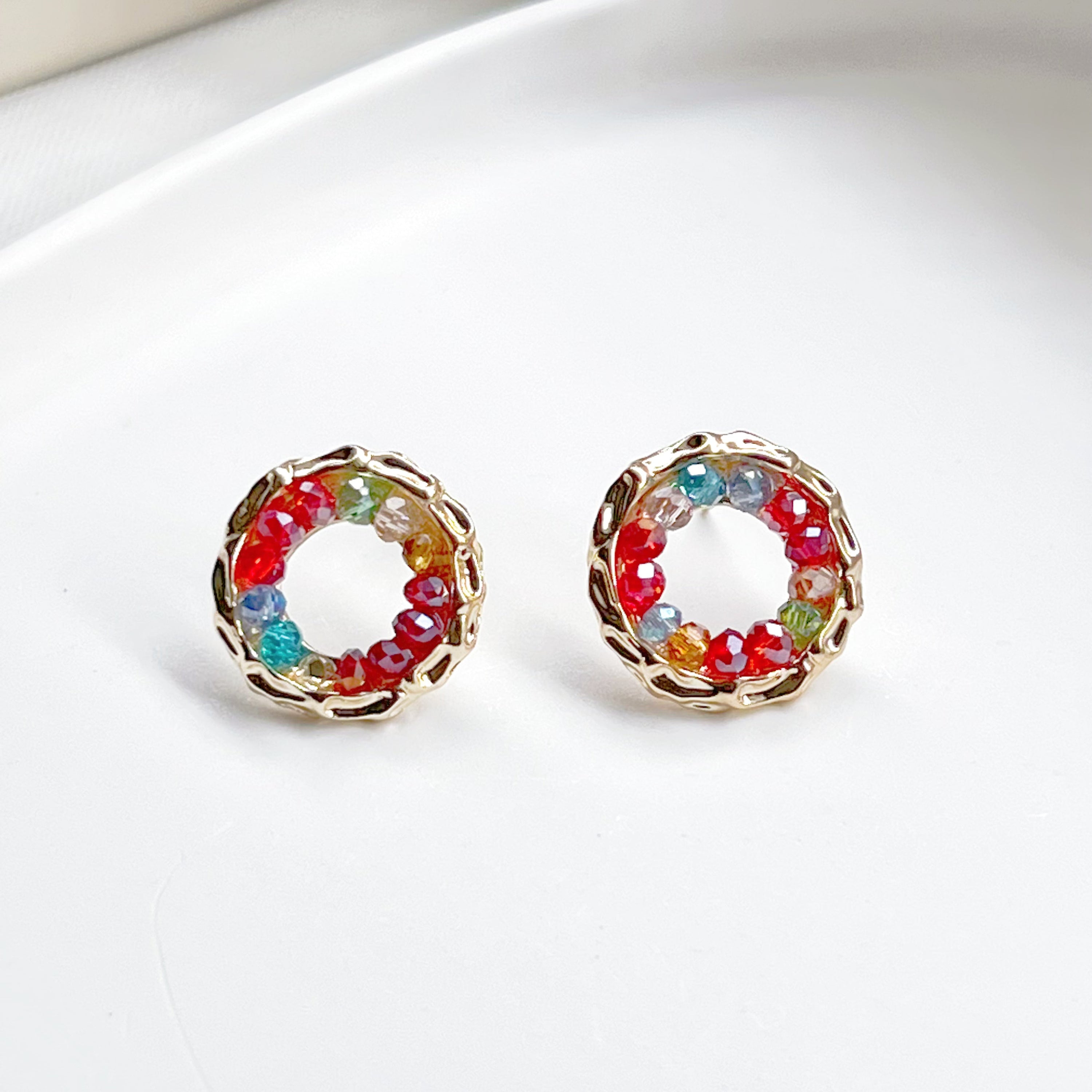 Colorful rainbow beads in a gold circle stud earring design, perfect for summer outfits.