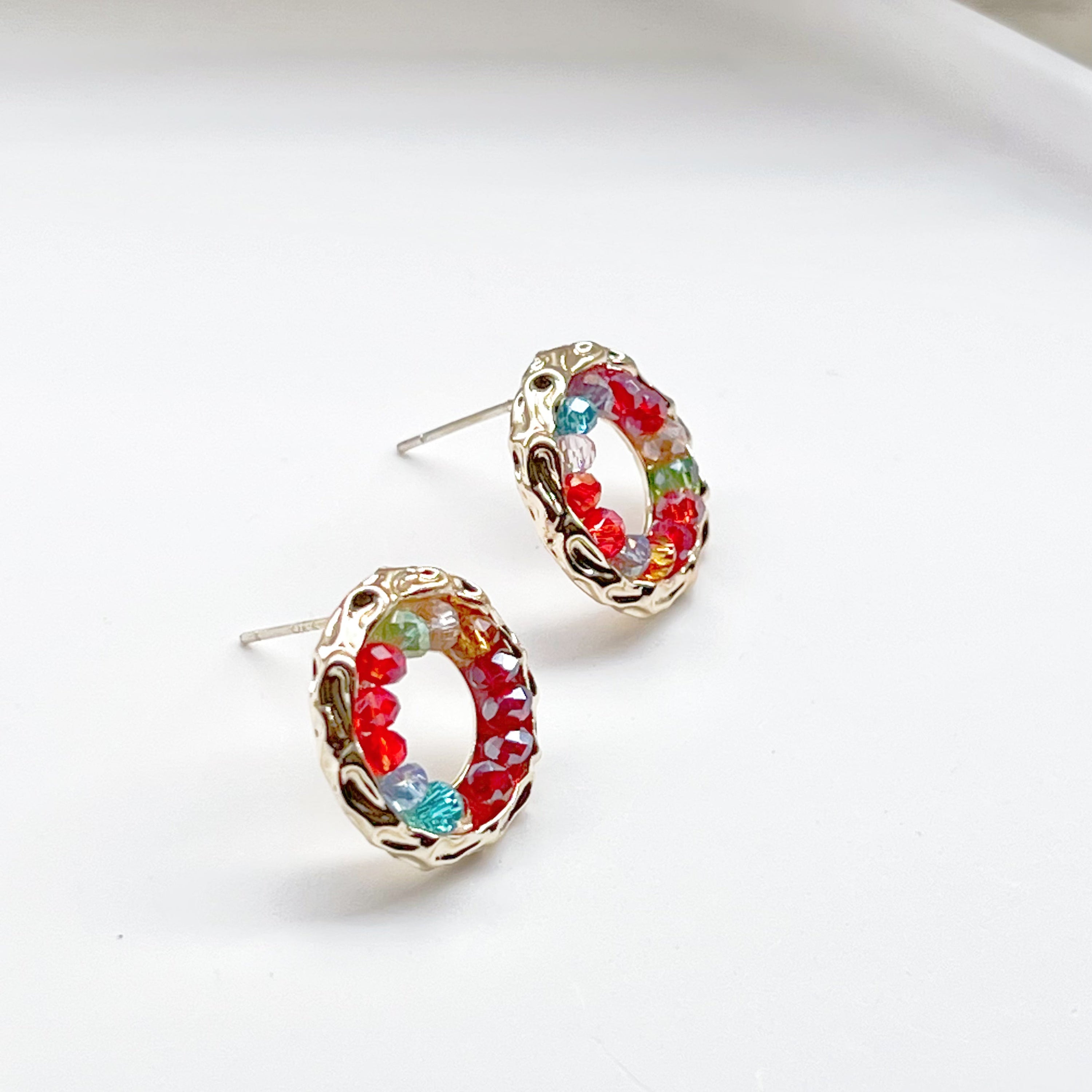 Colorful rainbow beads in a gold circle stud earring design, perfect for summer outfits.