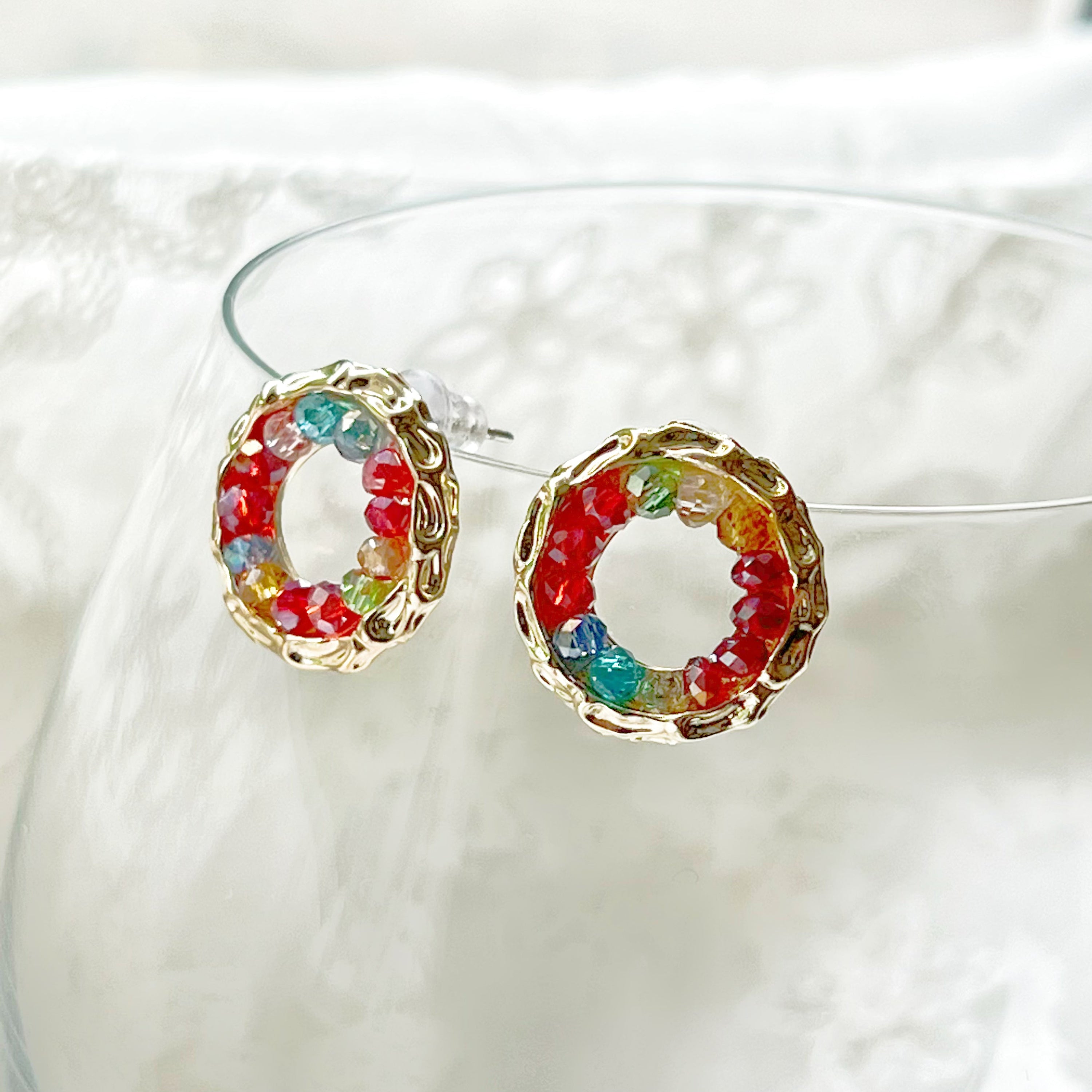 Colorful rainbow beads in a gold circle stud earring design, perfect for summer outfits.