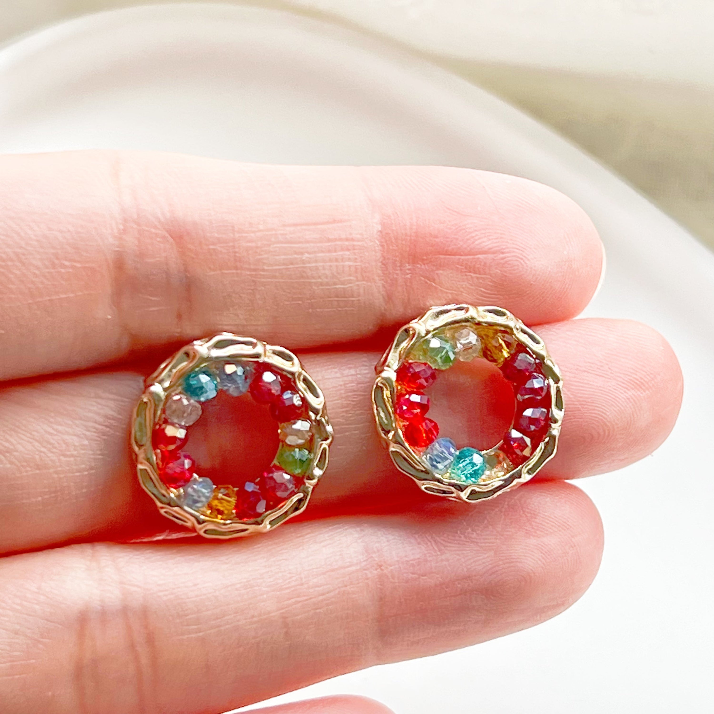 Colorful rainbow beads in a gold circle stud earring design, perfect for summer outfits.