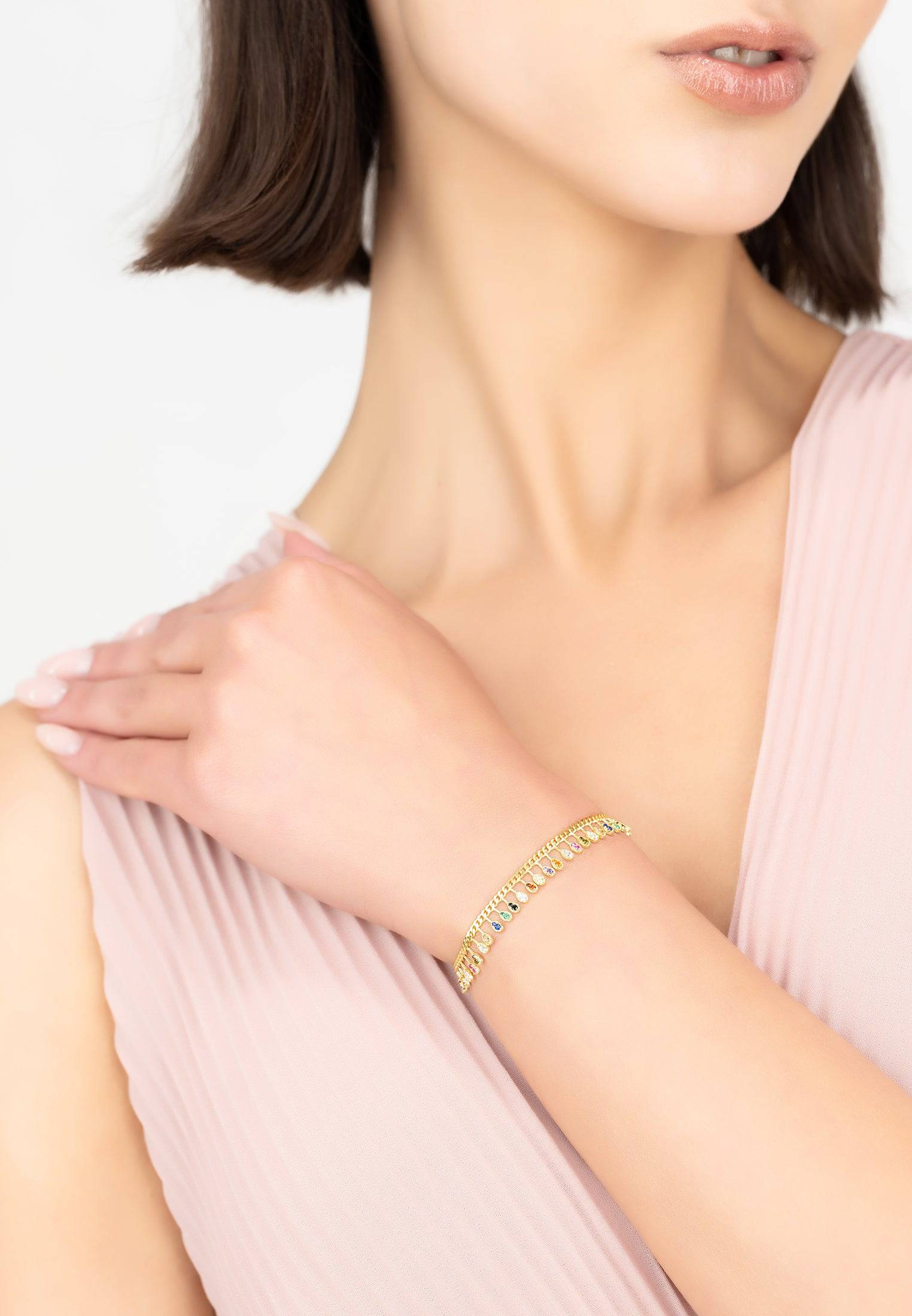 Rainbow Droplets Bracelet Gold featuring colorful zirconia droplets on a gold curb chain, elegantly designed for everyday wear.