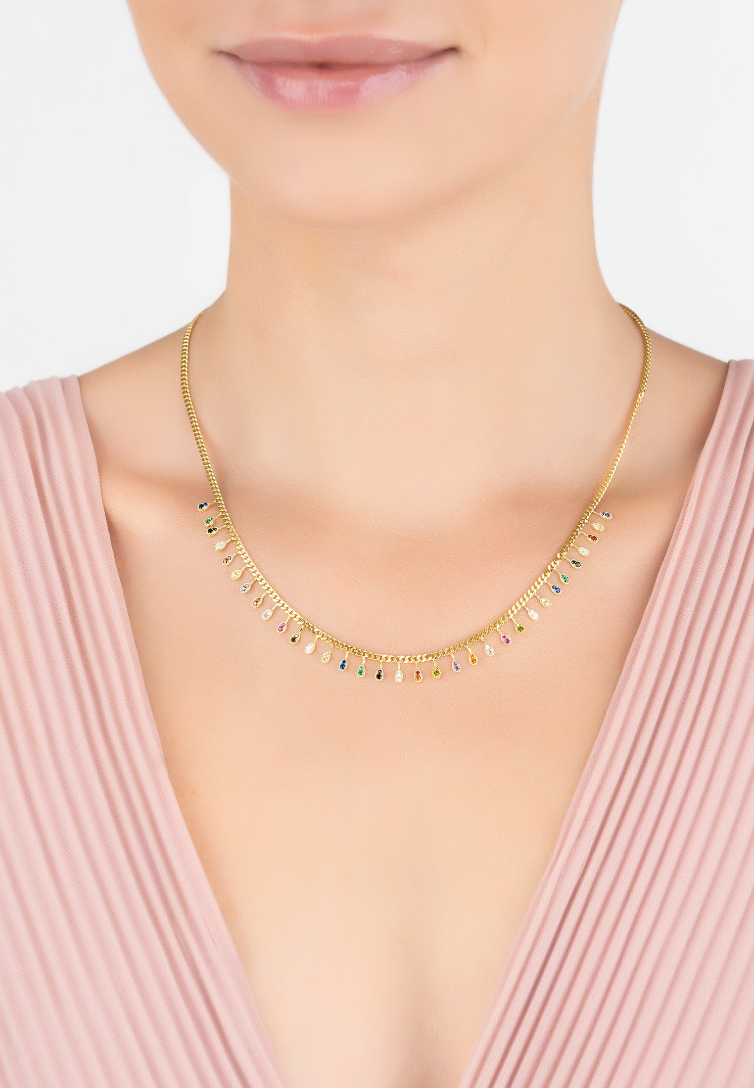 Rainbow Droplets Necklace Gold featuring colorful zirconia droplets on a gold curb chain, elegantly displayed.