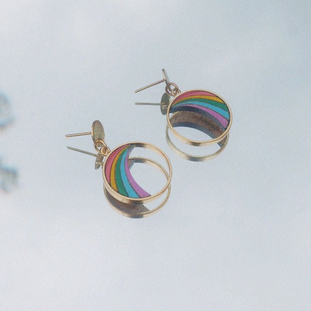 A pair of Rainbow Eco-friendly Recycled Wood Gold Earrings showcasing unique wood patterns and 24K gold plating, elegantly displayed in a luxury gift box.