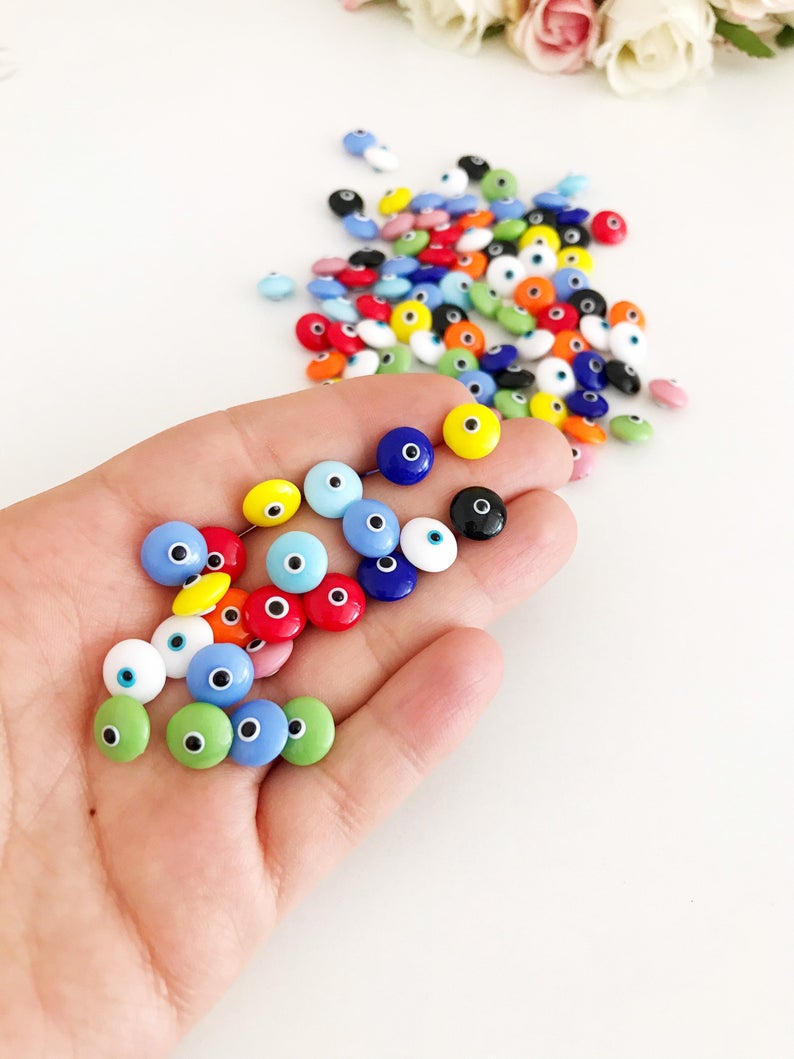 A collection of colorful Rainbow Evil Eye Cabochons, showcasing various designs and colors, perfect for DIY jewelry making.