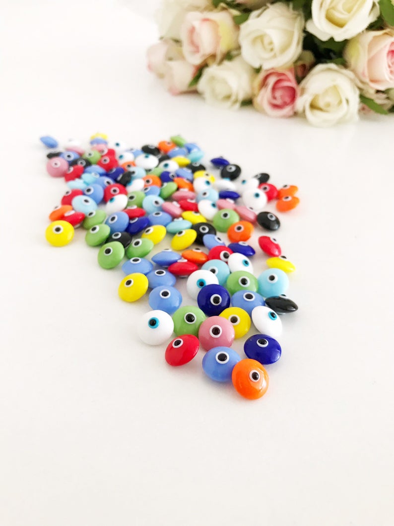 A collection of colorful Rainbow Evil Eye Cabochons, showcasing various designs and colors, perfect for DIY jewelry making.