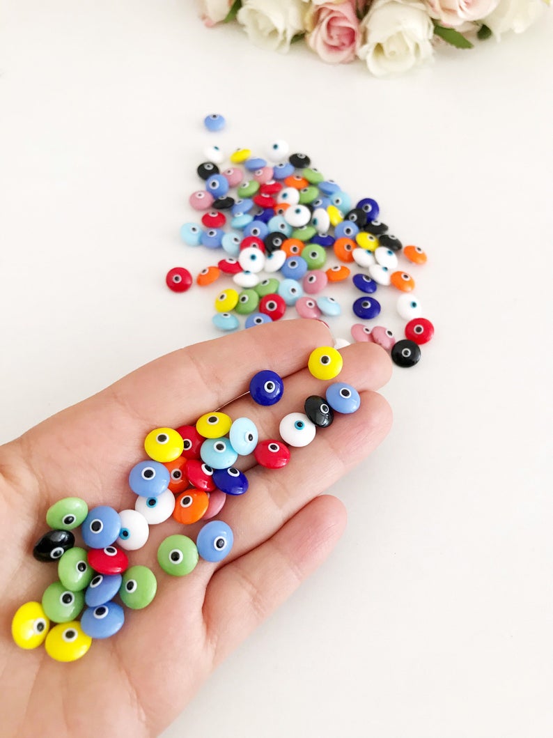 A collection of colorful Rainbow Evil Eye Cabochons, showcasing various designs and colors, perfect for DIY jewelry making.