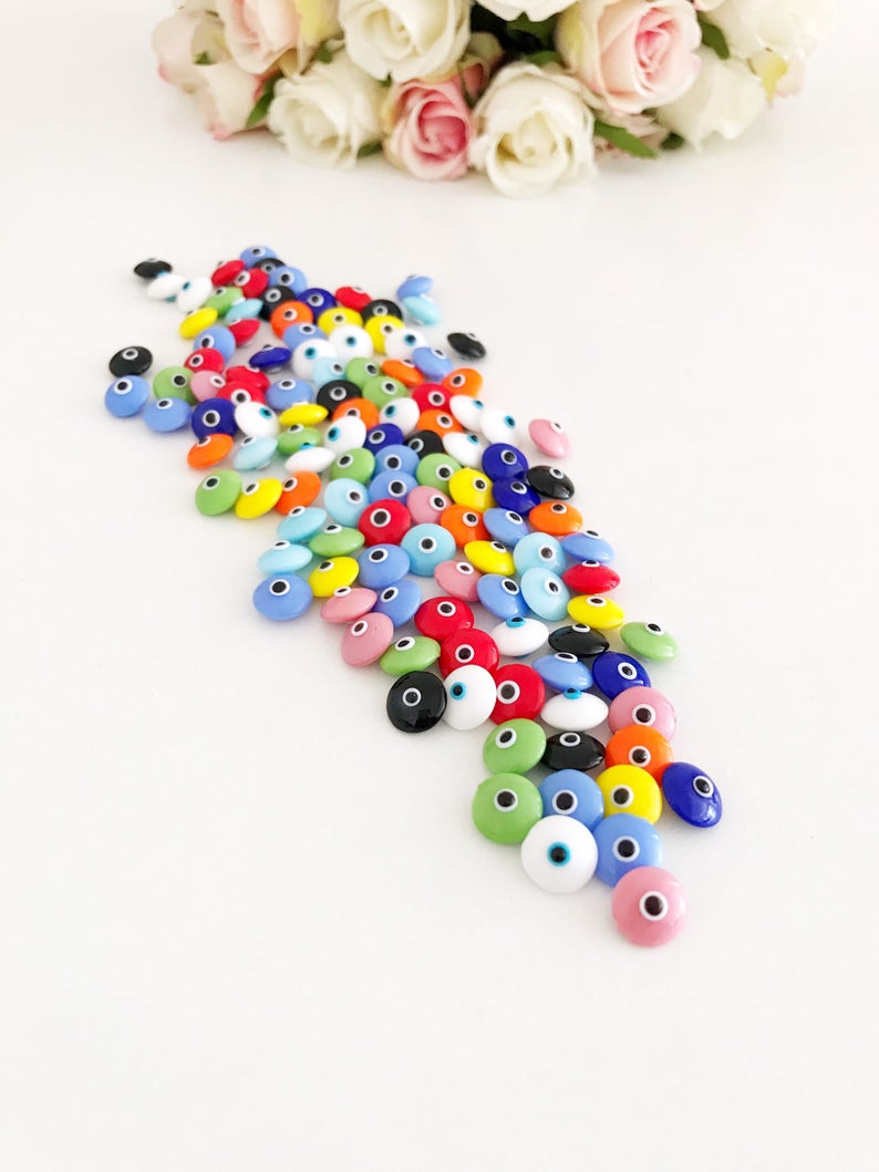 A collection of colorful Rainbow Evil Eye Cabochons, showcasing various designs and colors, perfect for DIY jewelry making.