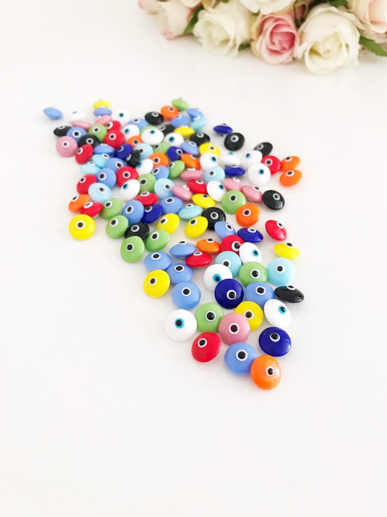 A collection of colorful Rainbow Evil Eye Cabochons, showcasing various designs and colors, perfect for DIY jewelry making.