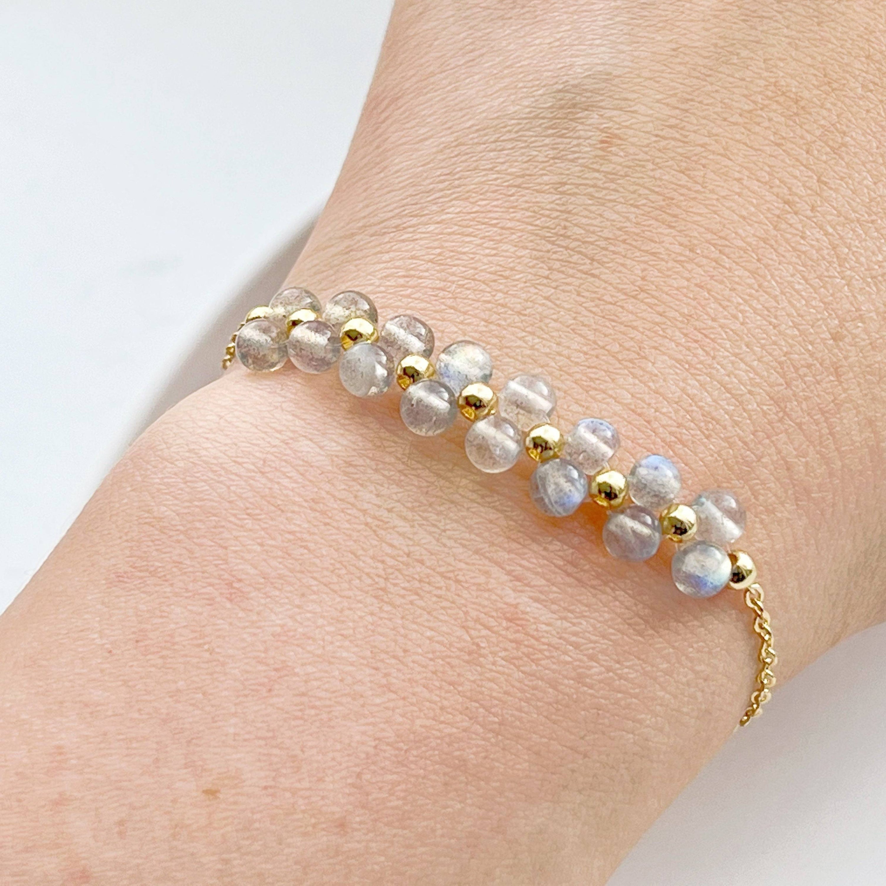 A stunning Rainbow Moonstone Bracelet featuring natural moonstone beads and gold-tone accents, elegantly displayed on a soft background.