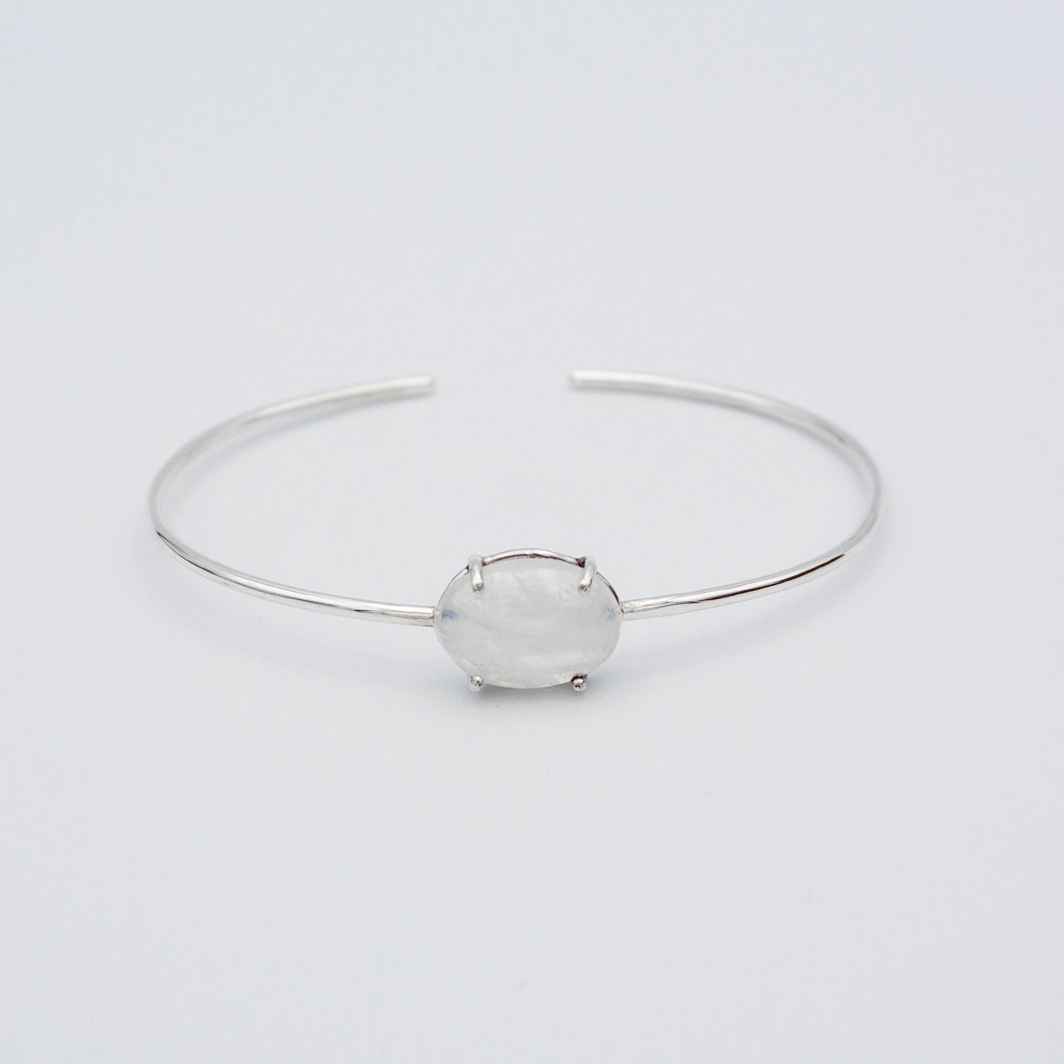 A beautiful Rainbow Moonstone Sterling Silver Cuff Bracelet showcasing a natural 10x12mm gemstone set in .925 sterling silver.