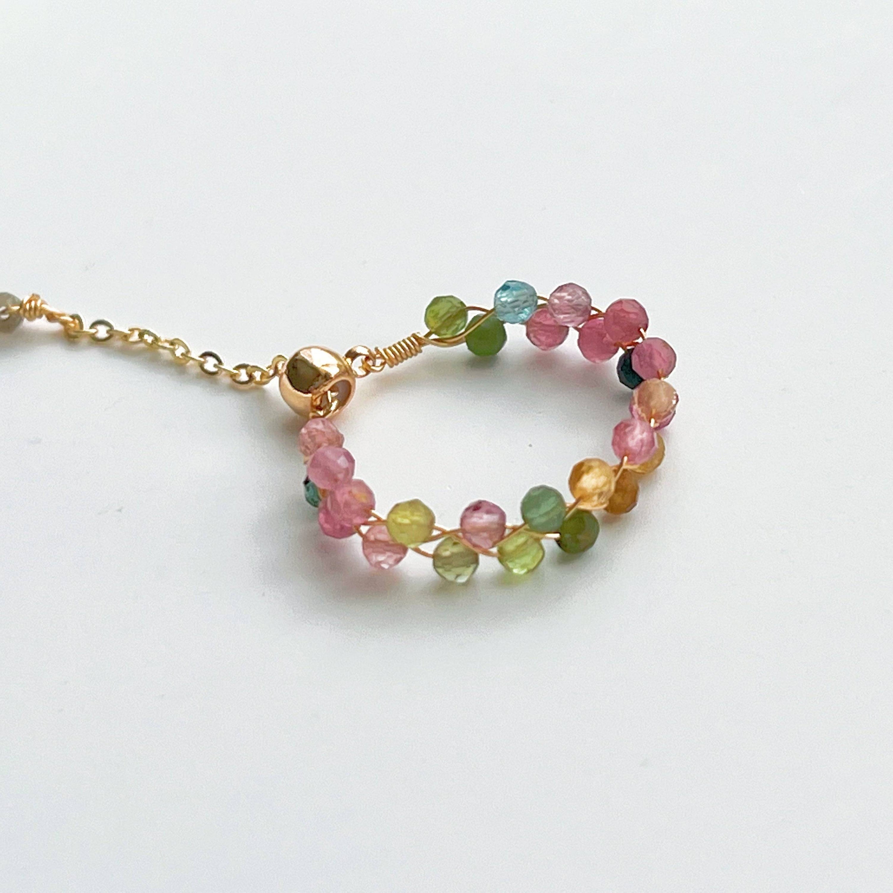 Rainbow Tourmaline Beaded Ring featuring adjustable gold plated bronze wire and vibrant natural gemstones.