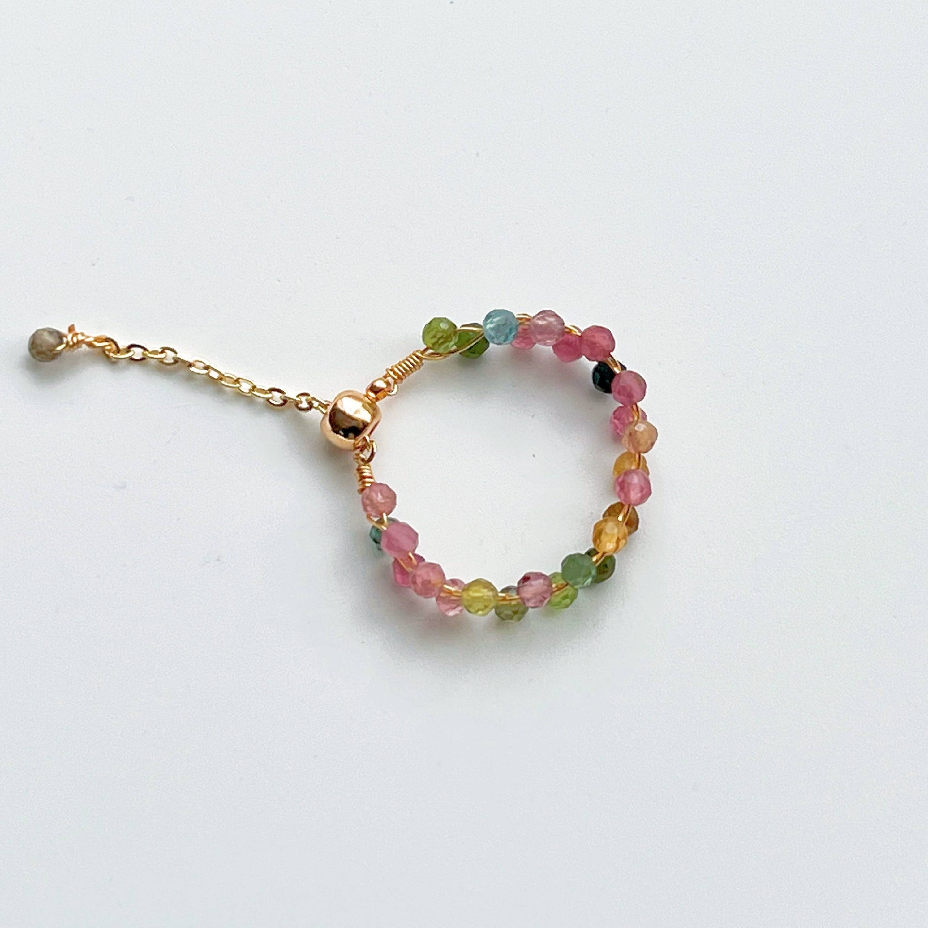 Rainbow Tourmaline Beaded Ring featuring adjustable gold plated bronze wire and vibrant natural gemstones.