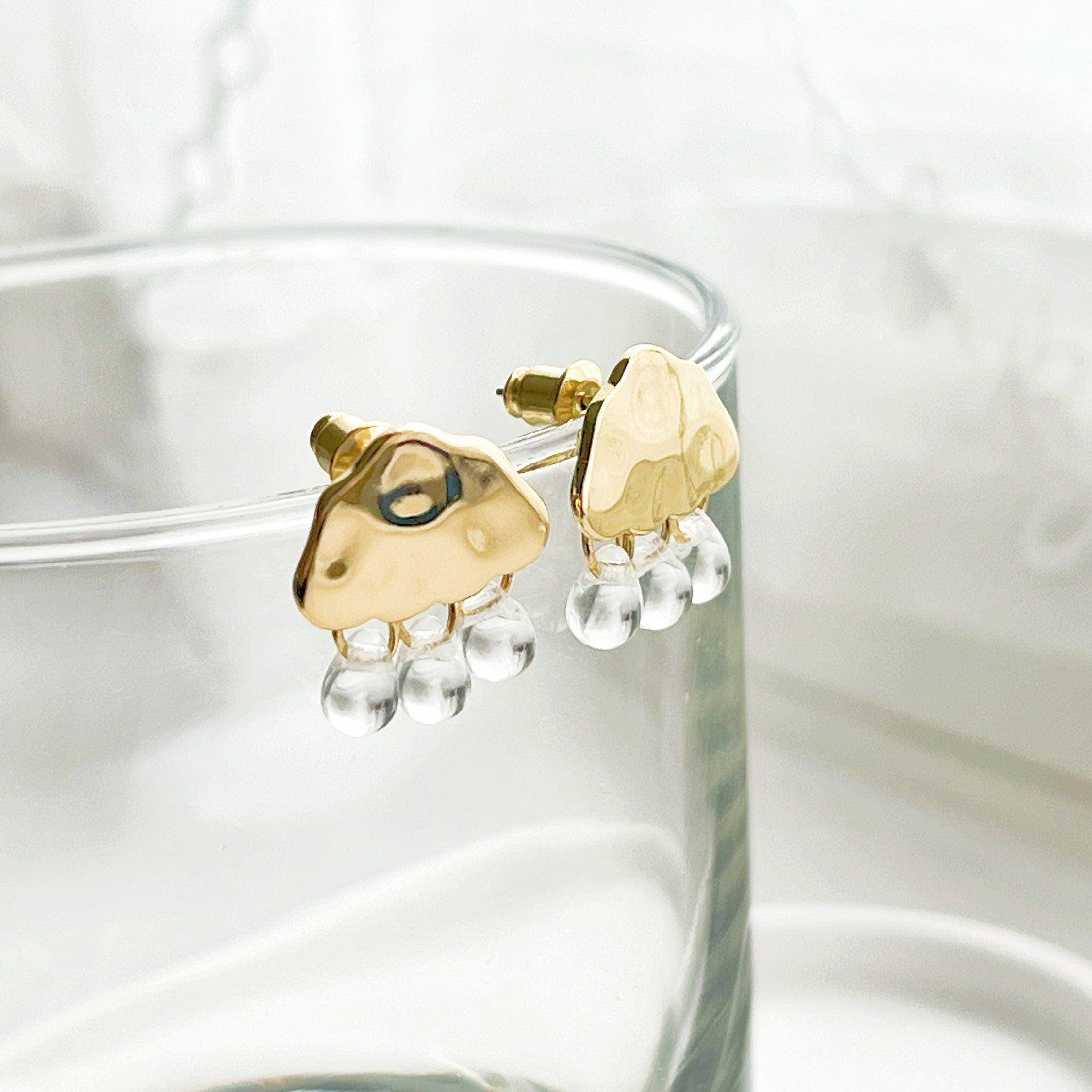 Raining Day Earrings featuring gold cloud design with crystal rain drops, elegantly displayed in a gift box.