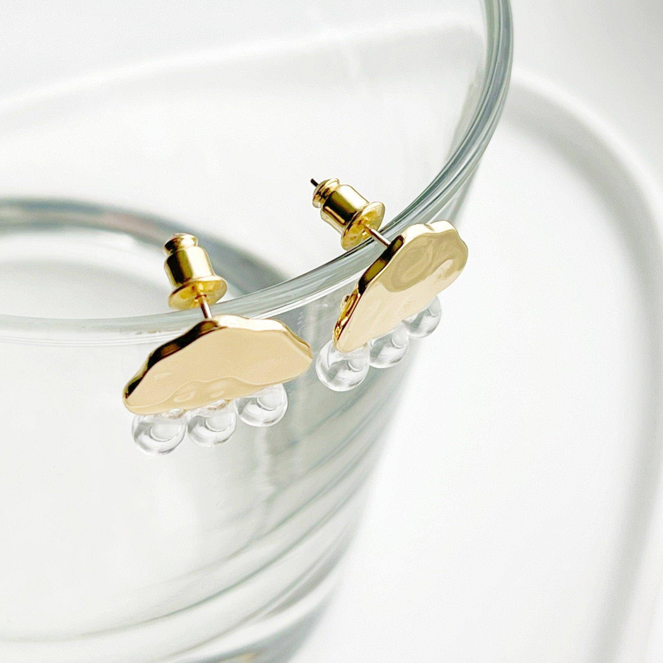 Raining Day Earrings featuring gold cloud design with crystal rain drops, elegantly displayed in a gift box.