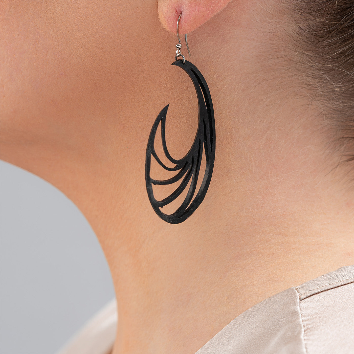 Handcrafted Ram Statement Inner Tube Earrings made from recycled rubber, featuring a unique ram horn-inspired design with sterling silver hooks.