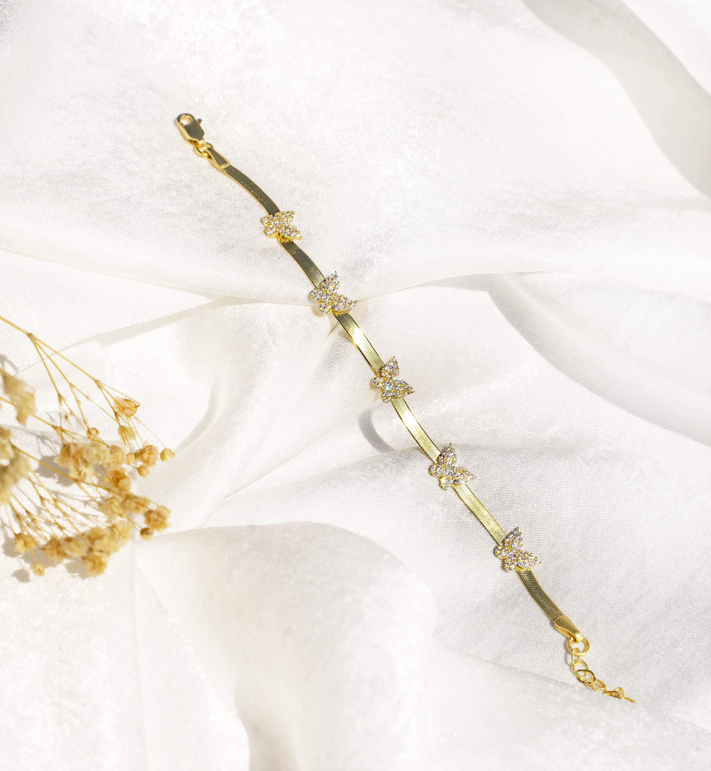 RANA Bracelet featuring butterfly charms in 925 sterling silver with yellow gold plating and sparkling cubic zirconias.