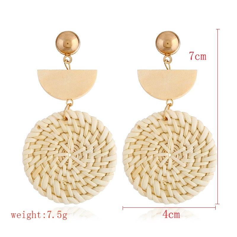 A pair of elegant Rattan Earrings featuring organic wooden straw weave and wood bead embellishments, perfect for eco-conscious fashion lovers.