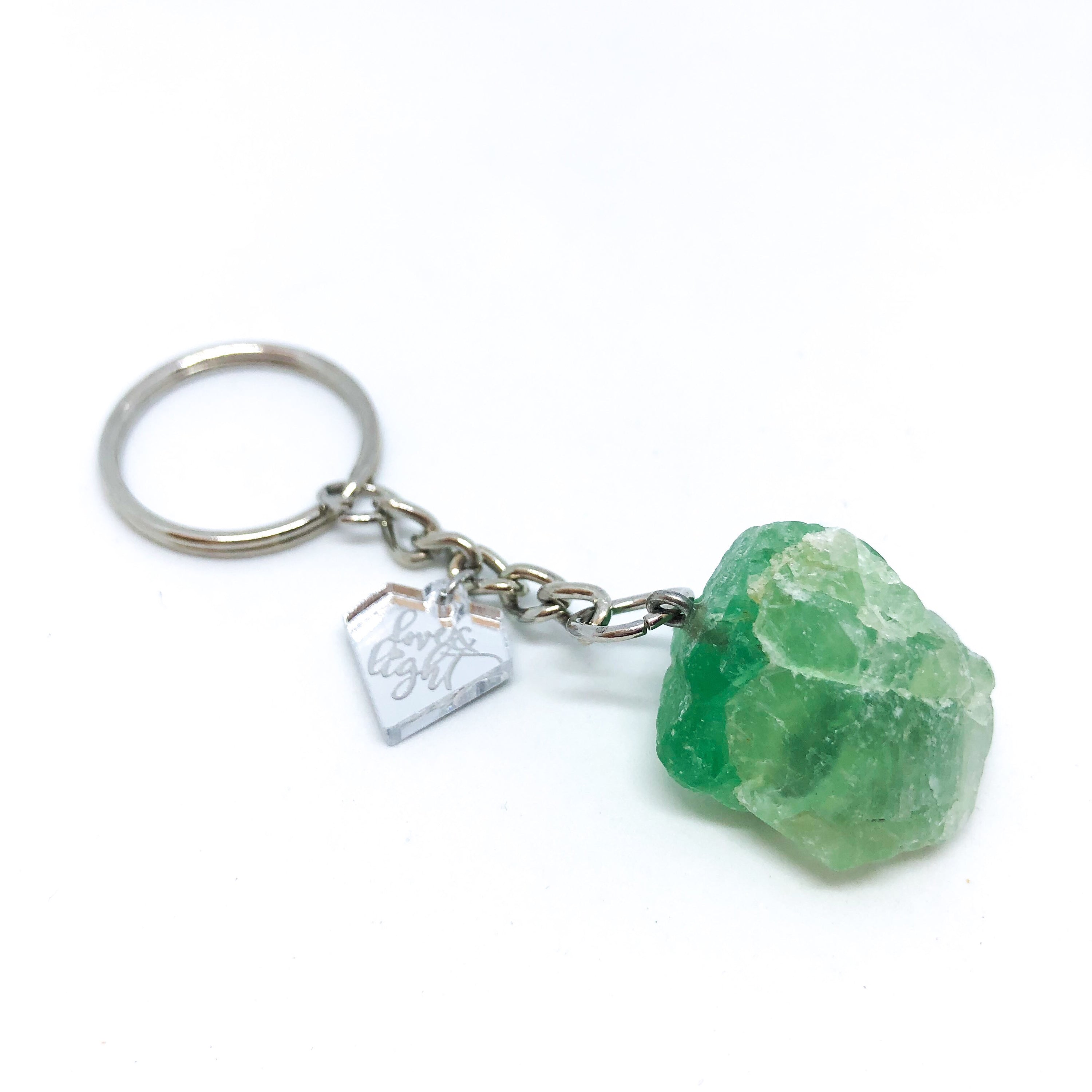 A collection of unique Raw Crystal Keychains featuring natural raw cut crystals in various shapes and sizes, accented with a silver LLJ charm.