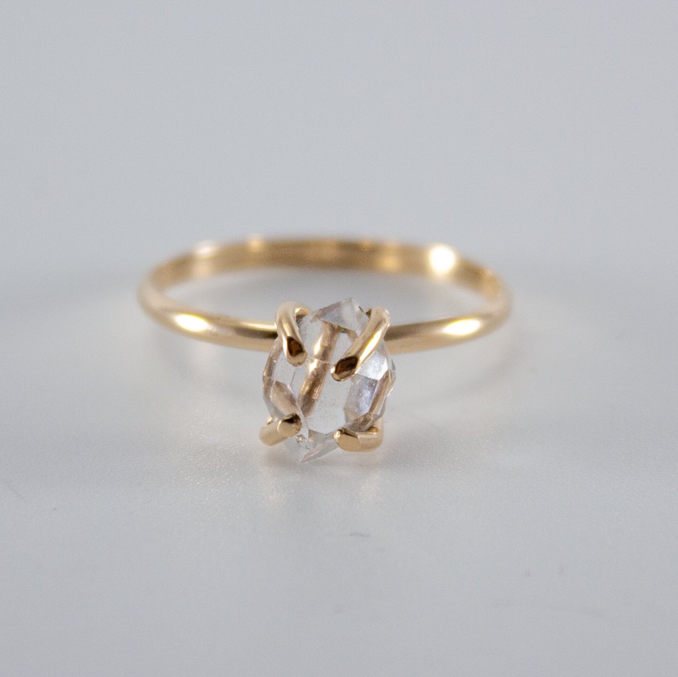 A stunning Raw Herkimer Diamond set in a 14k gold filled prong ring, showcasing its natural brilliance and unique shape.