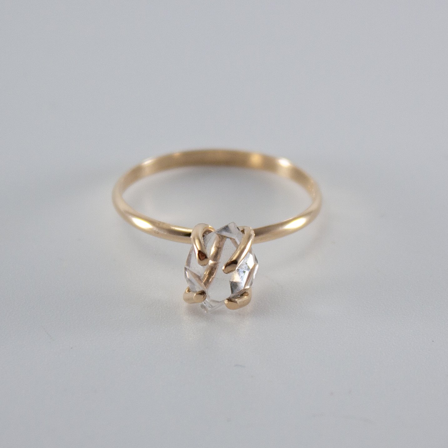 A stunning Raw Herkimer Diamond set in a 14k gold filled prong ring, showcasing its natural brilliance and unique shape.